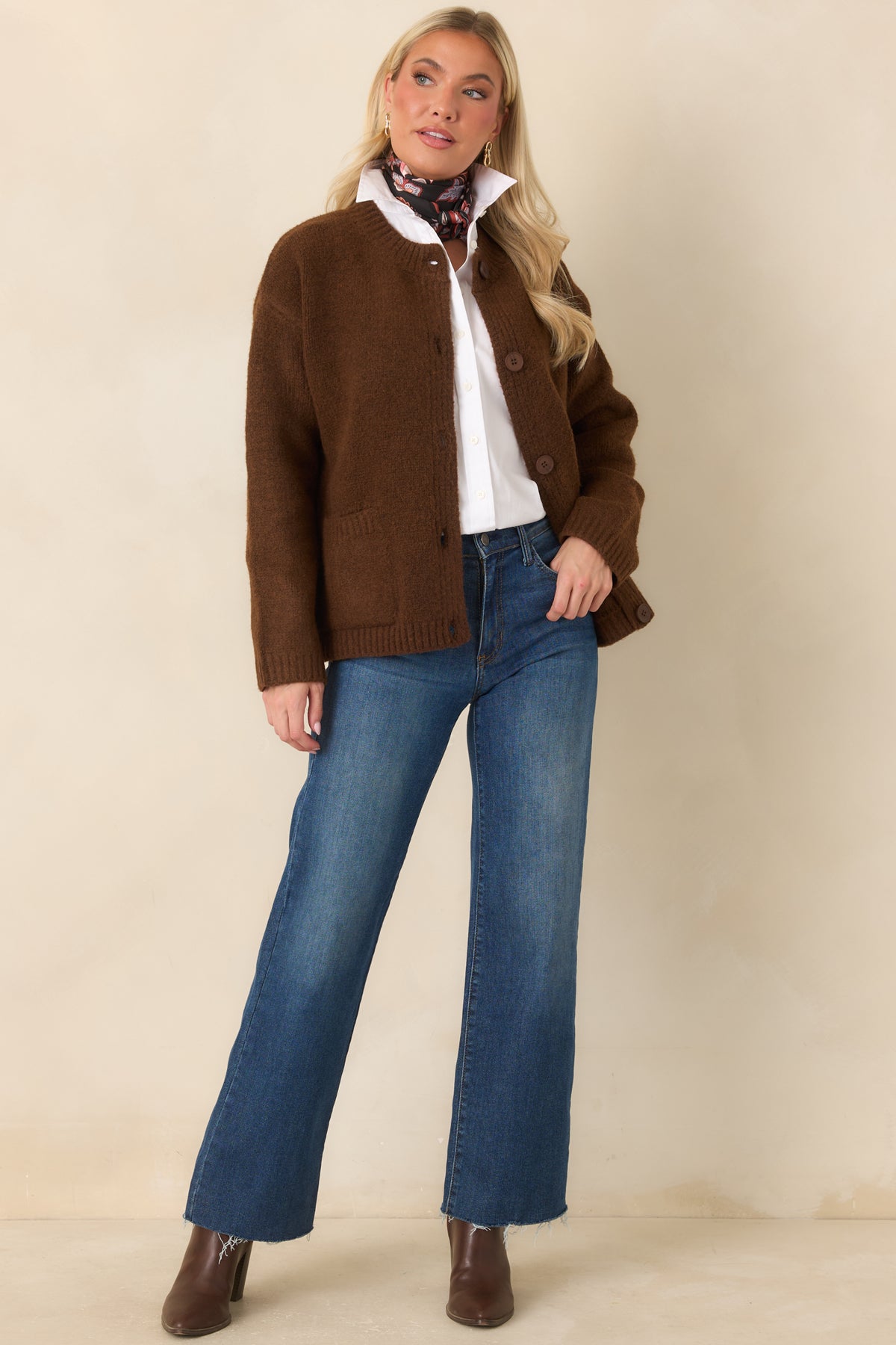 A warm chestnut hue and tonal buttons complement the cozy knit texture and ribbed hem of this relaxed cardigan.