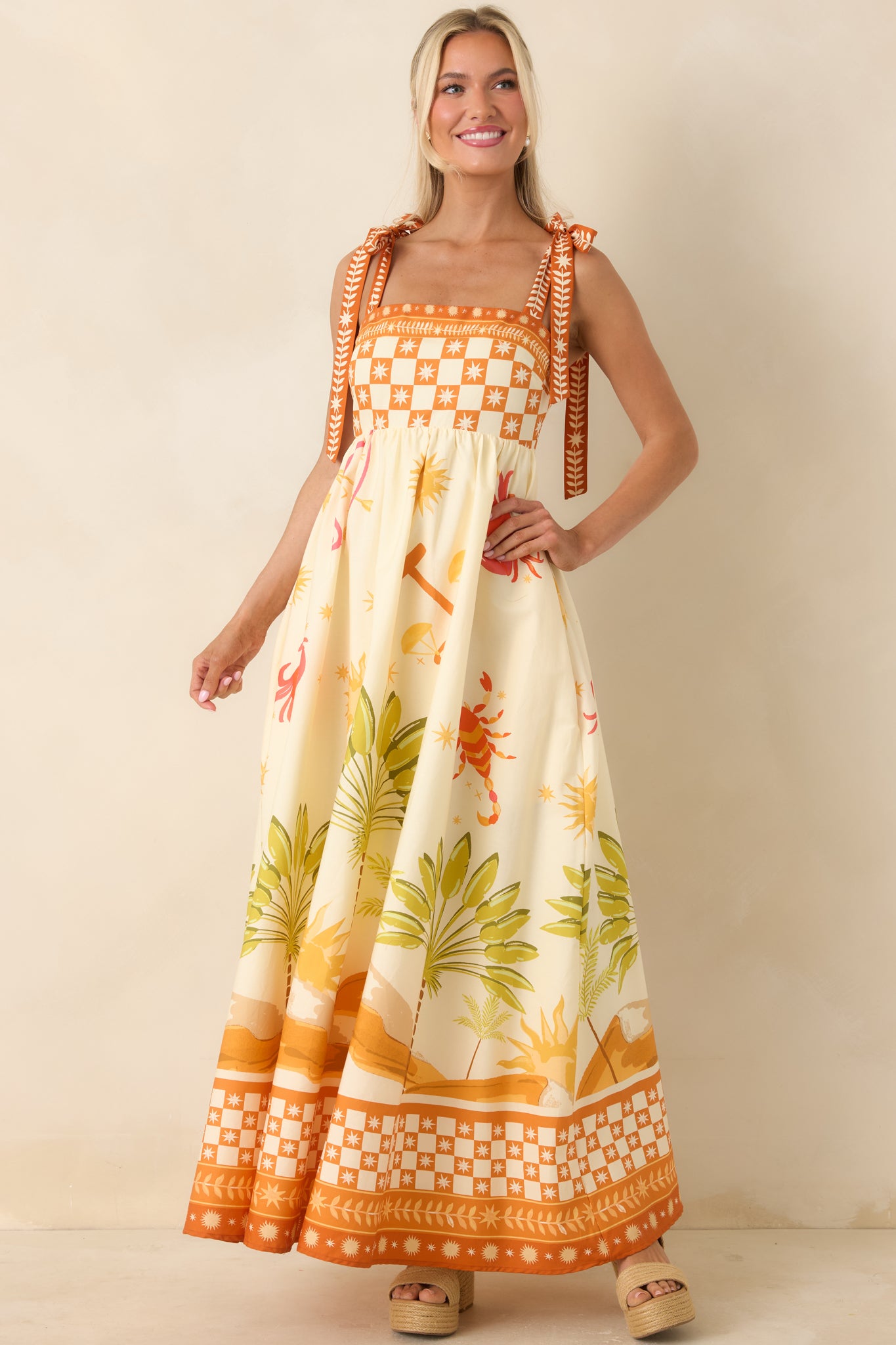 Patterned maxi dress with soft cotton fabric, fitted top, and relaxed full-length skirt.