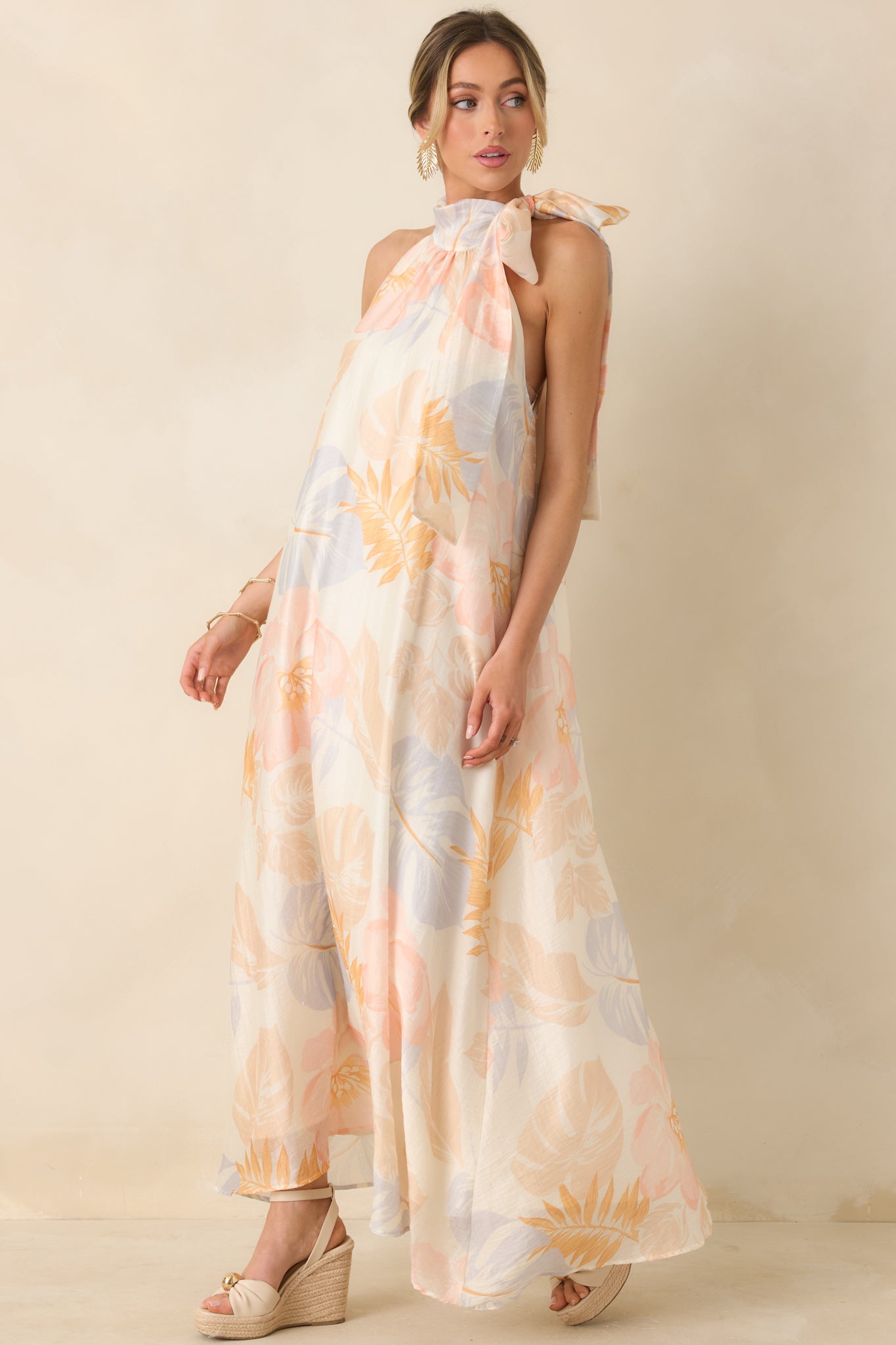 Halter maxi dress in ivory with adjustable side tie and breathable fabric blend.