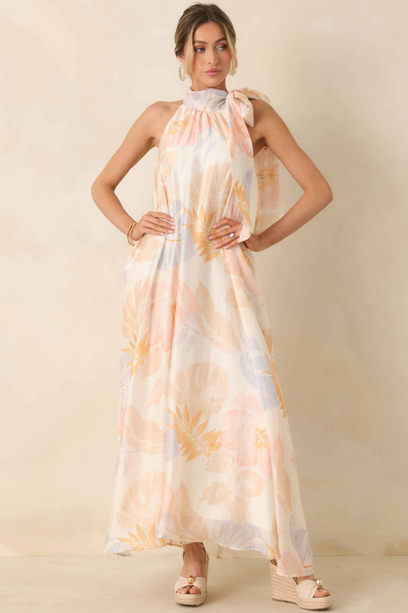 Full-length ivory dress with flowing skirt, side pockets, and modern halter detail.