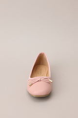 Front view of these flats that feature a square toe, bow detail, a matte finish, and a memory foam insole.