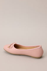 Inner-side view of these flats that feature a square toe, bow detail, a matte finish, and a memory foam insole.