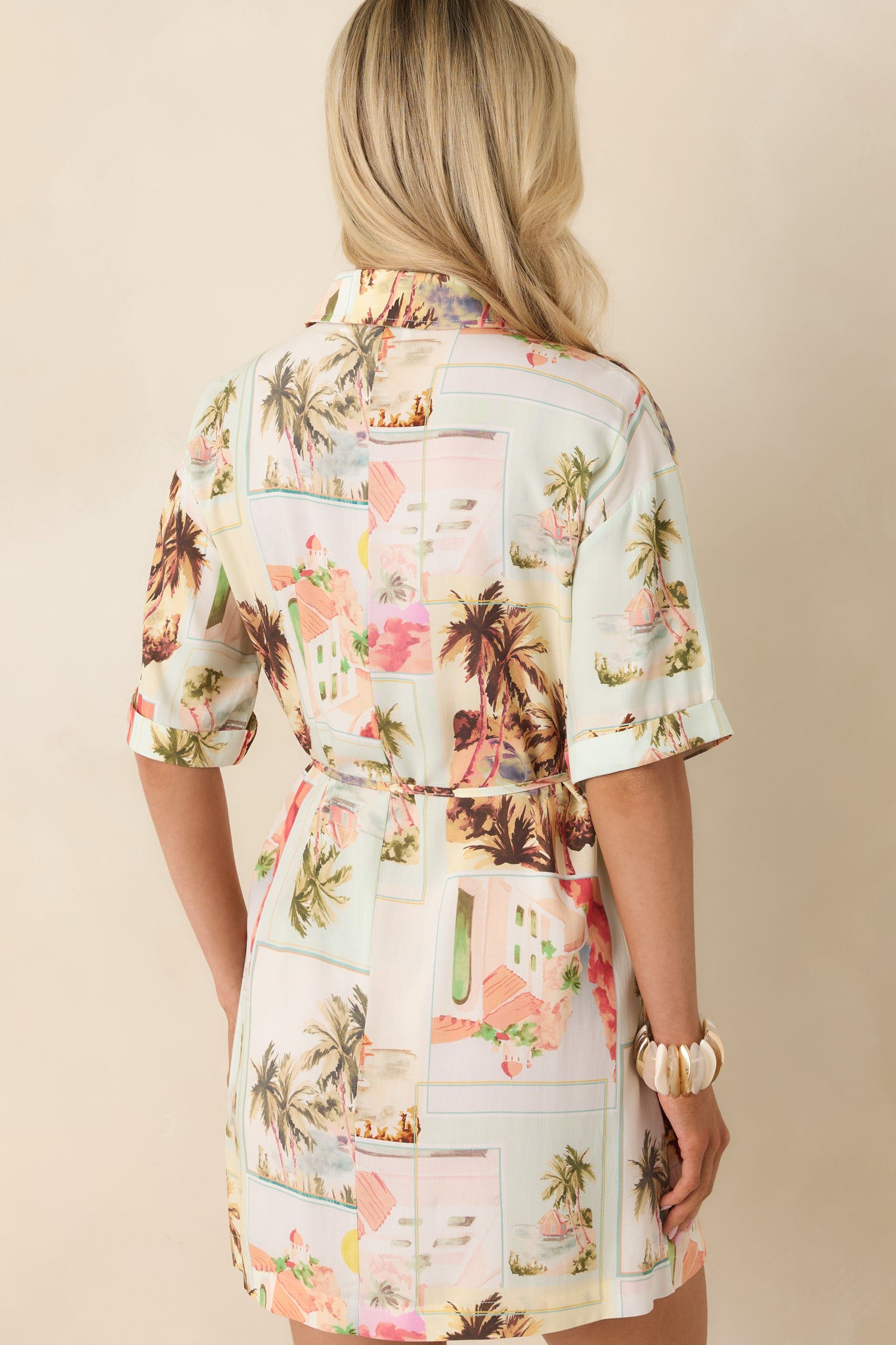 Back view of mini shirtdress featuring vintage postcard print with a relaxed fit and adjustable waist tie for a flattering shape