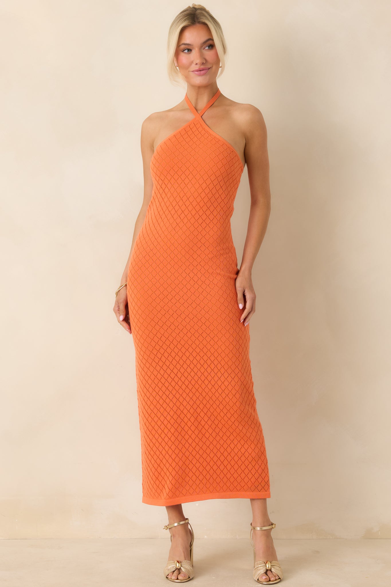 Form-fitting dress with dimensional knit pattern and clean design.