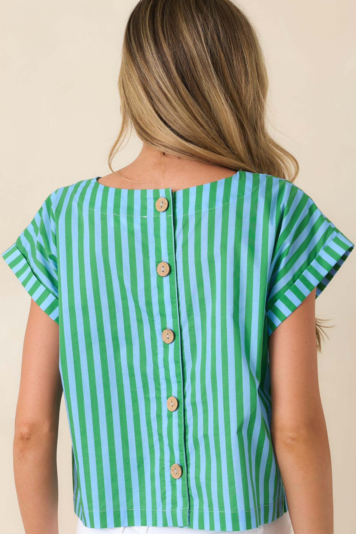Rear view of striped cotton top with back button closure and cropped hemline.