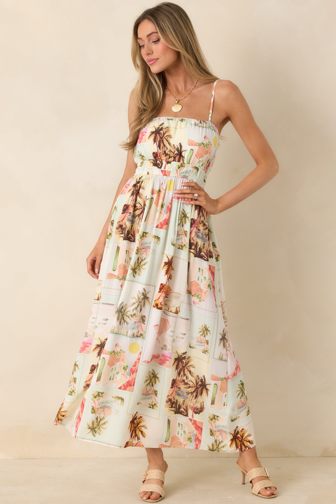 Front-facing view of lightweight midi sundress featuring a soft sun-faded vintage print, gathered waist, and flowing LENZING™ viscose fabric.