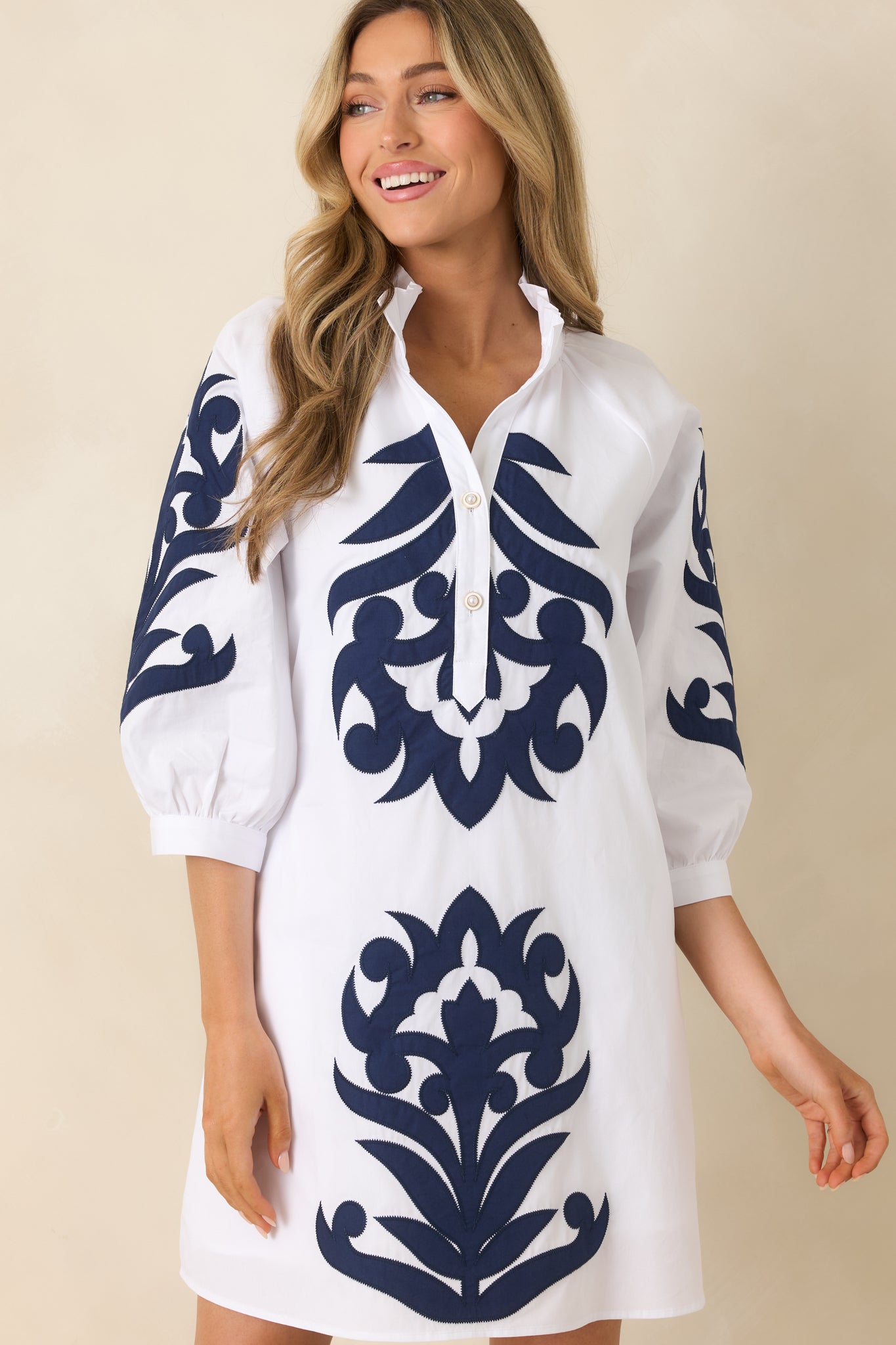 Detailed cropped view of white fabric with bold navy contrast accents.