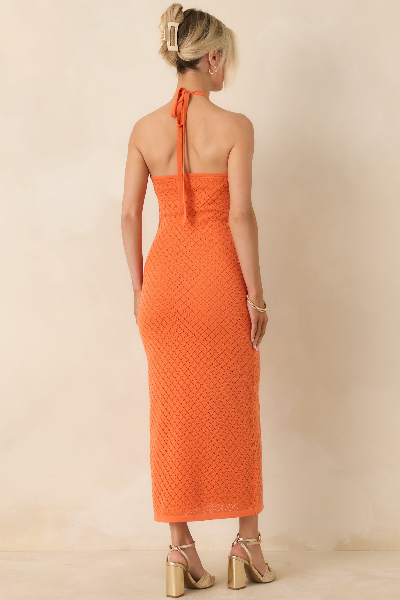 Rear view of fitted dress with smooth body-skimming silhouette.