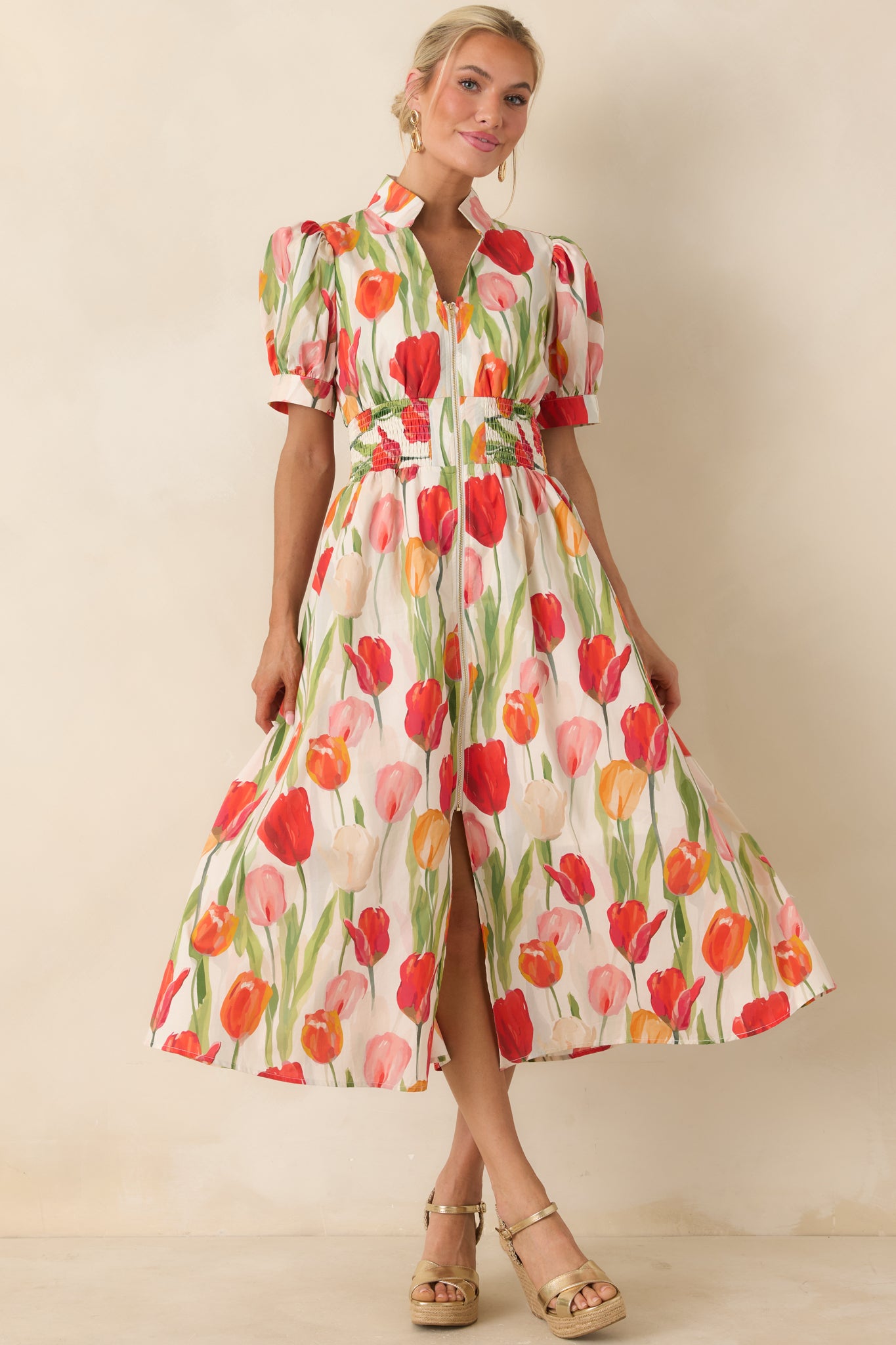 Ivory midi dress with vibrant tulip print, puff sleeves, and a smocked waist creating a softly defined shape.