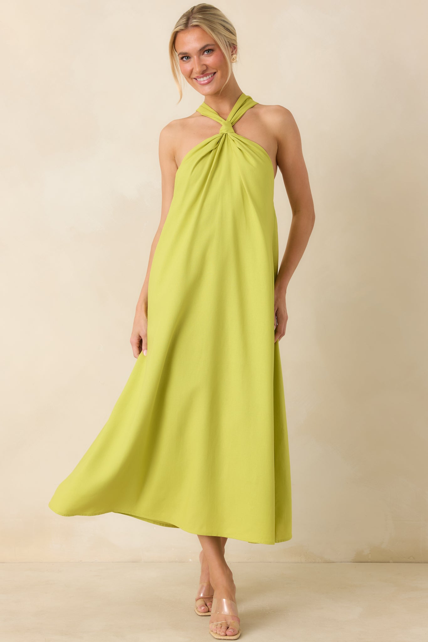 Lightweight chartreuse midi dress showcasing a soft linen texture, elegant halter design, and breezy full-length shape.