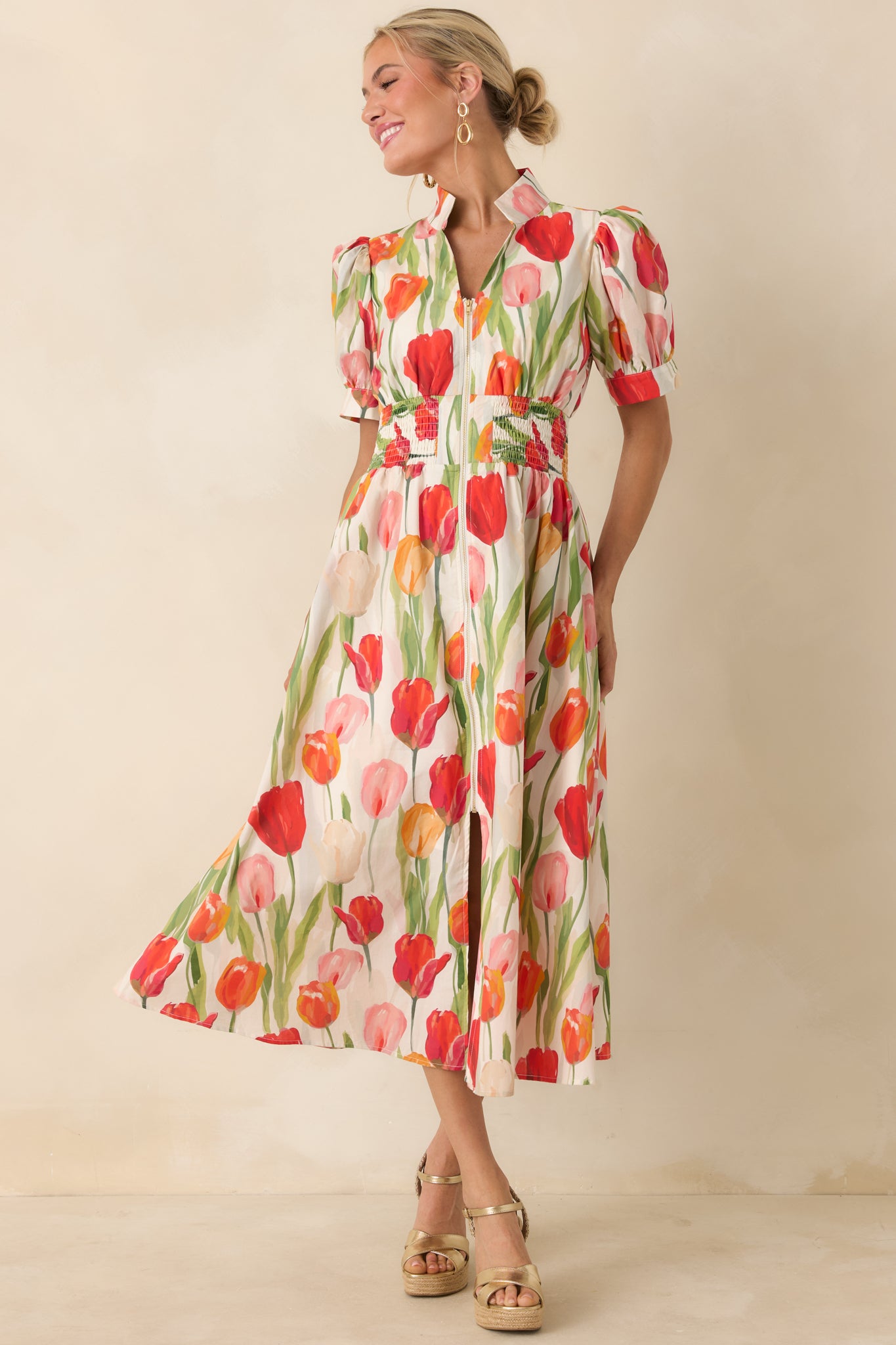Ivory dress with colorful tulip pattern, front zipper detail, and a cinched smocked waistline.