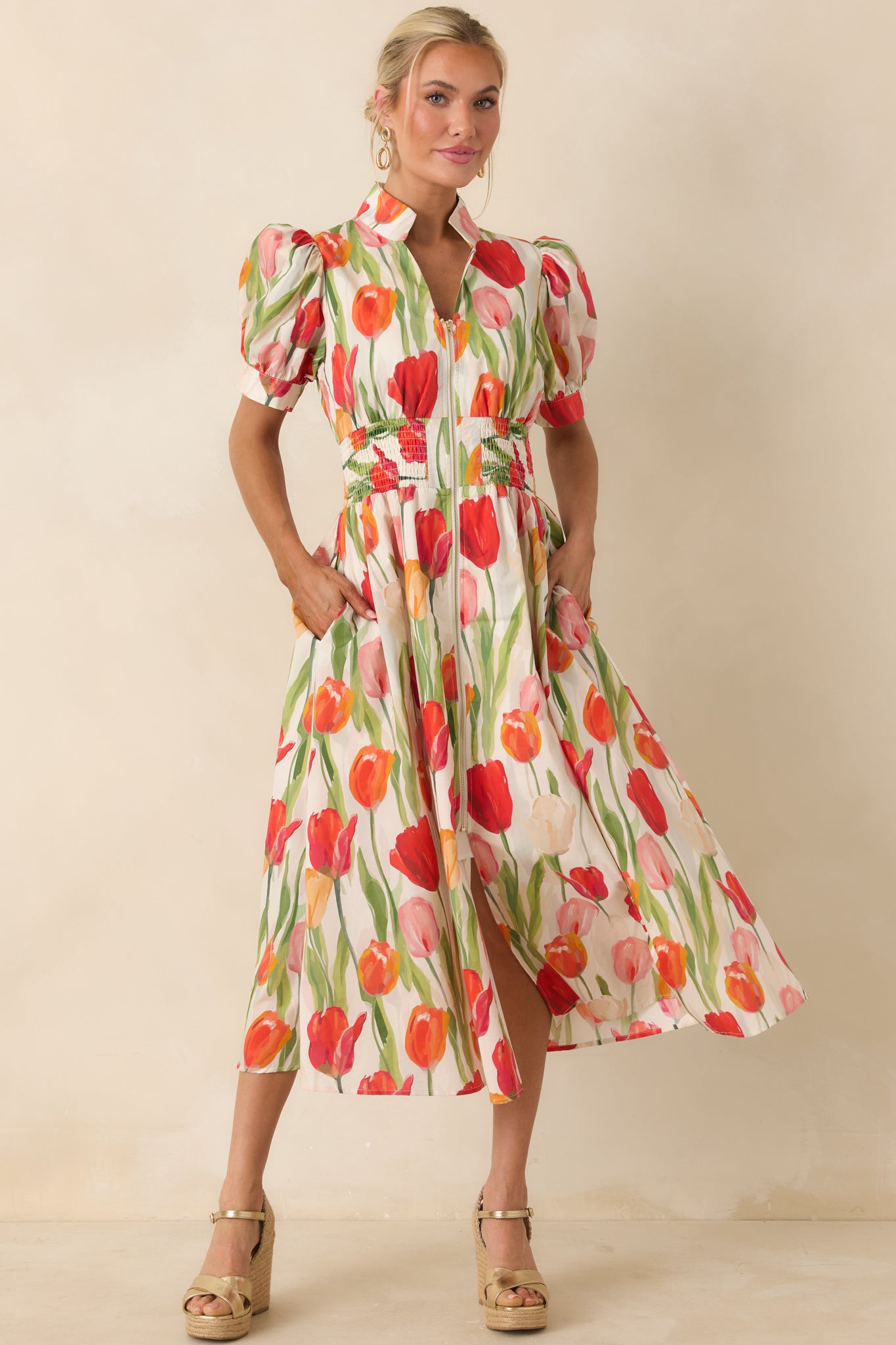 Multi-color tulip print midi dress with puff sleeves and a structured top flowing into a full skirt.