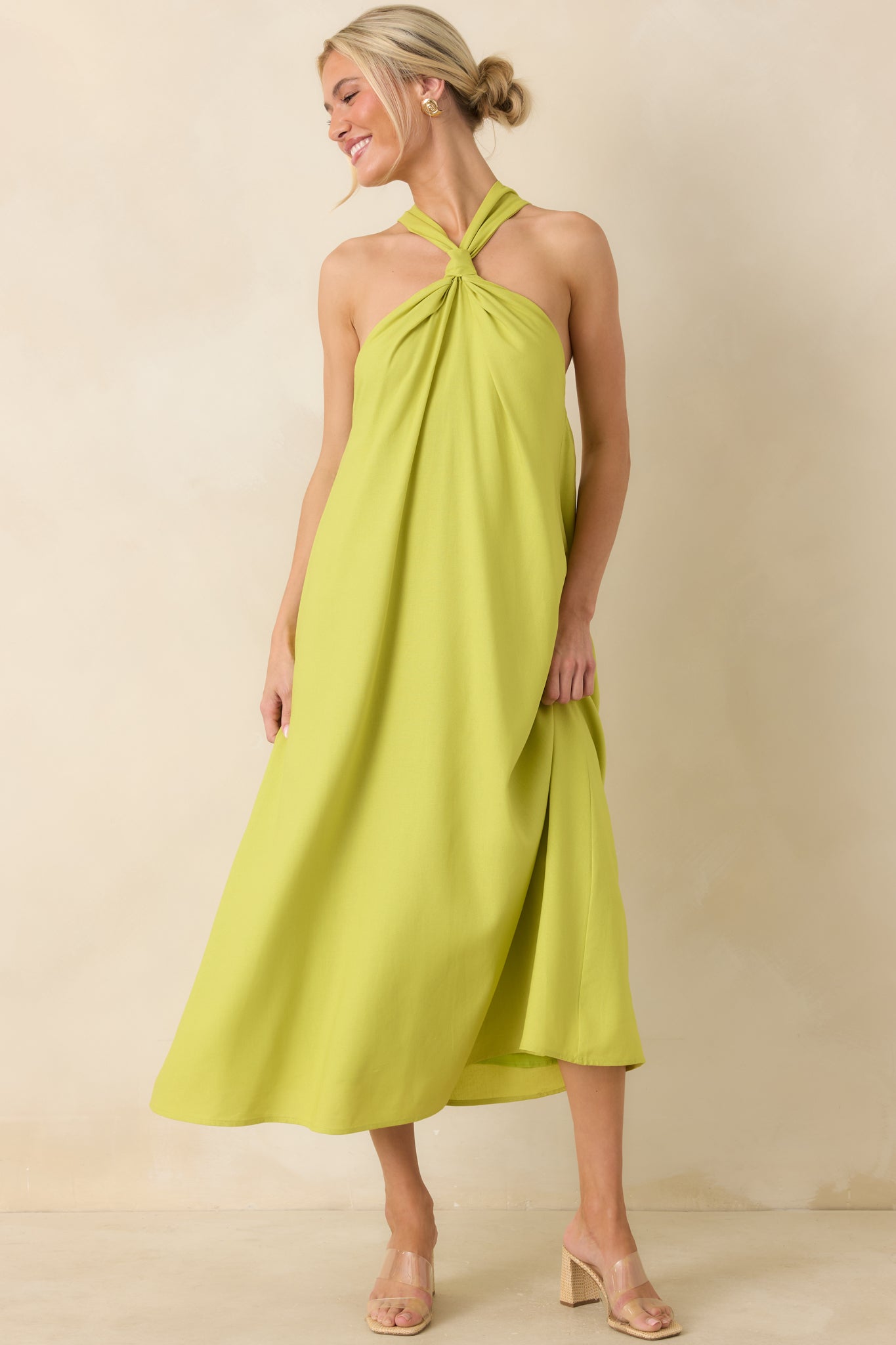 Chartreuse linen blend midi dress showcasing the open-back inspired halter design, twisted front detail, and airy fit.