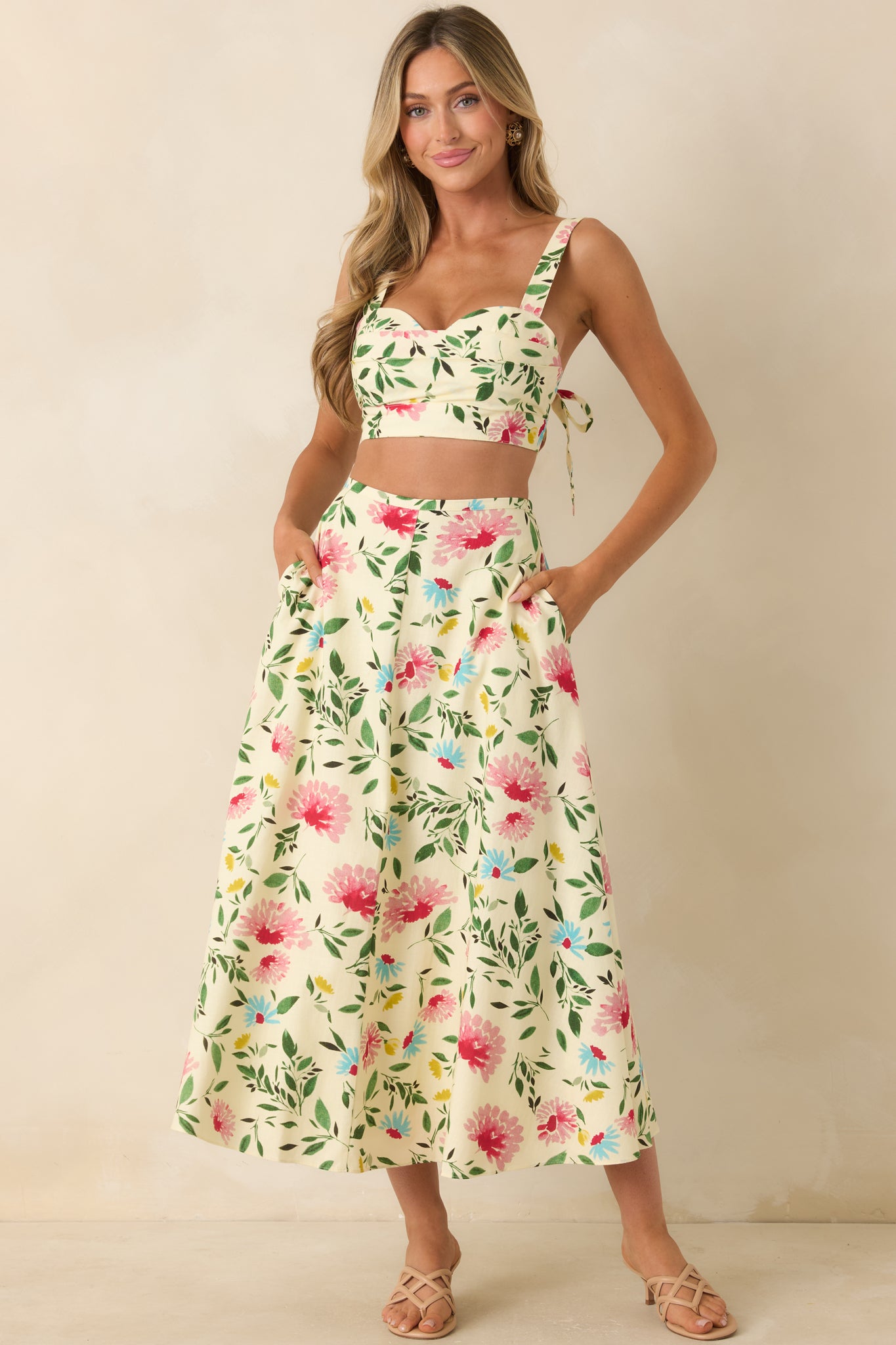 High-waisted midi skirt showcasing a soft ivory base with vibrant floral patterning and an easy, graceful drape.