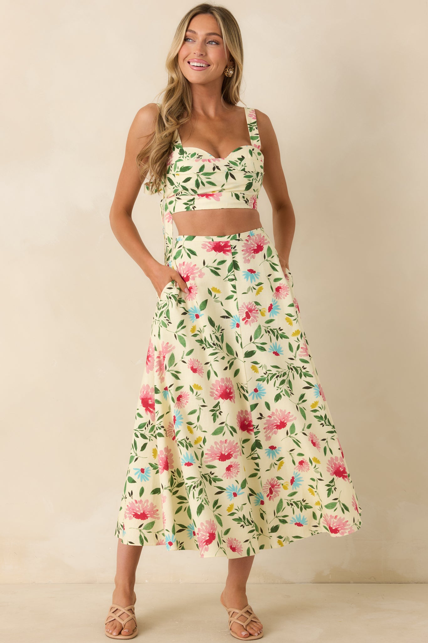 Flowing A-line skirt in a midi length design featuring a bright floral print throughout and a structured waistband.