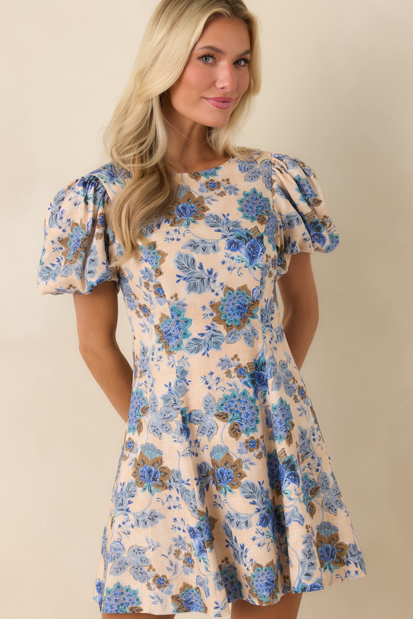 Close view of blue floral print with round neckline and bodice structure.