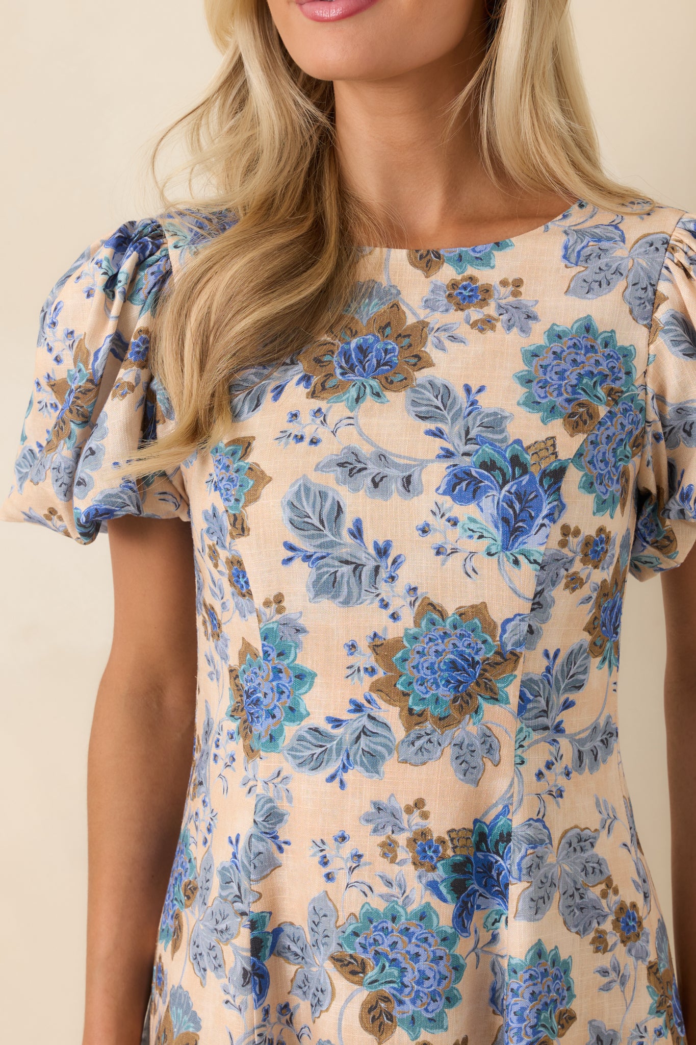 Close-up of blue floral print fabric with open back tie detail.
