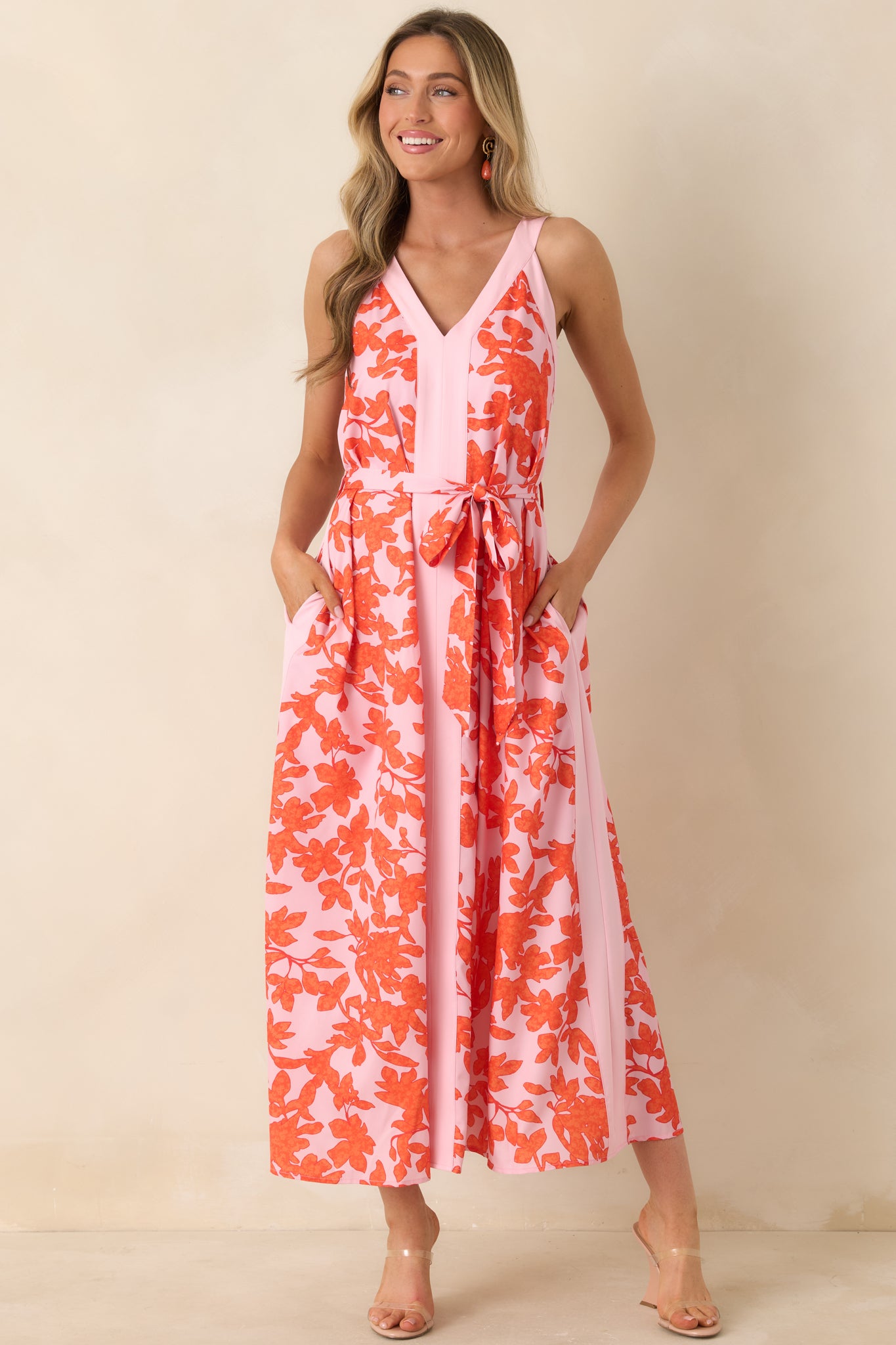 Lightweight dress with V-neckline, vibrant orange flowers, and relaxed, airy silhouette.