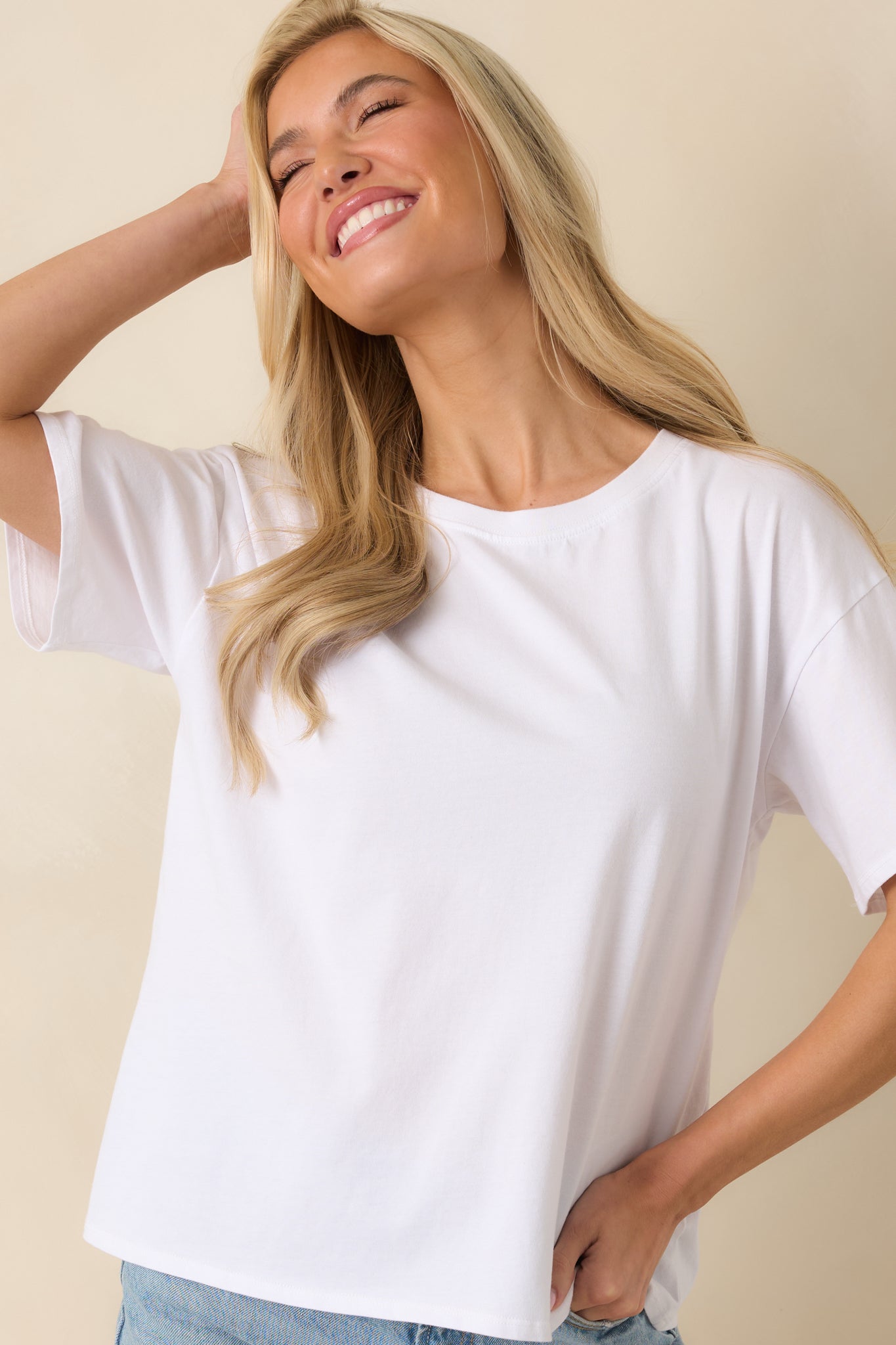 Soft cotton white top with simple crew neck and easy tuck-friendly construction.