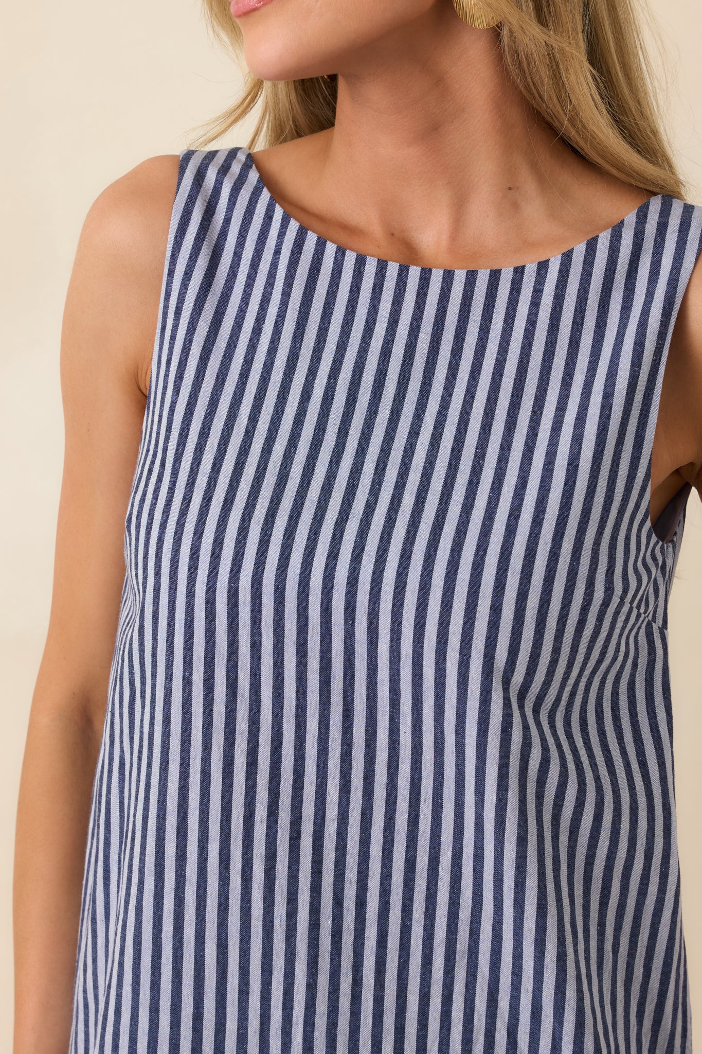 Close-up of blue and white pinstripe fabric with smooth texture and refined weave.