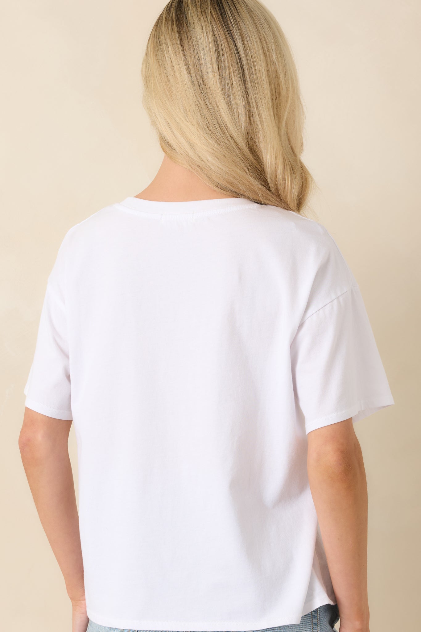 Rear view of white cotton tee featuring a smooth finish and feminine fitted silhouette.