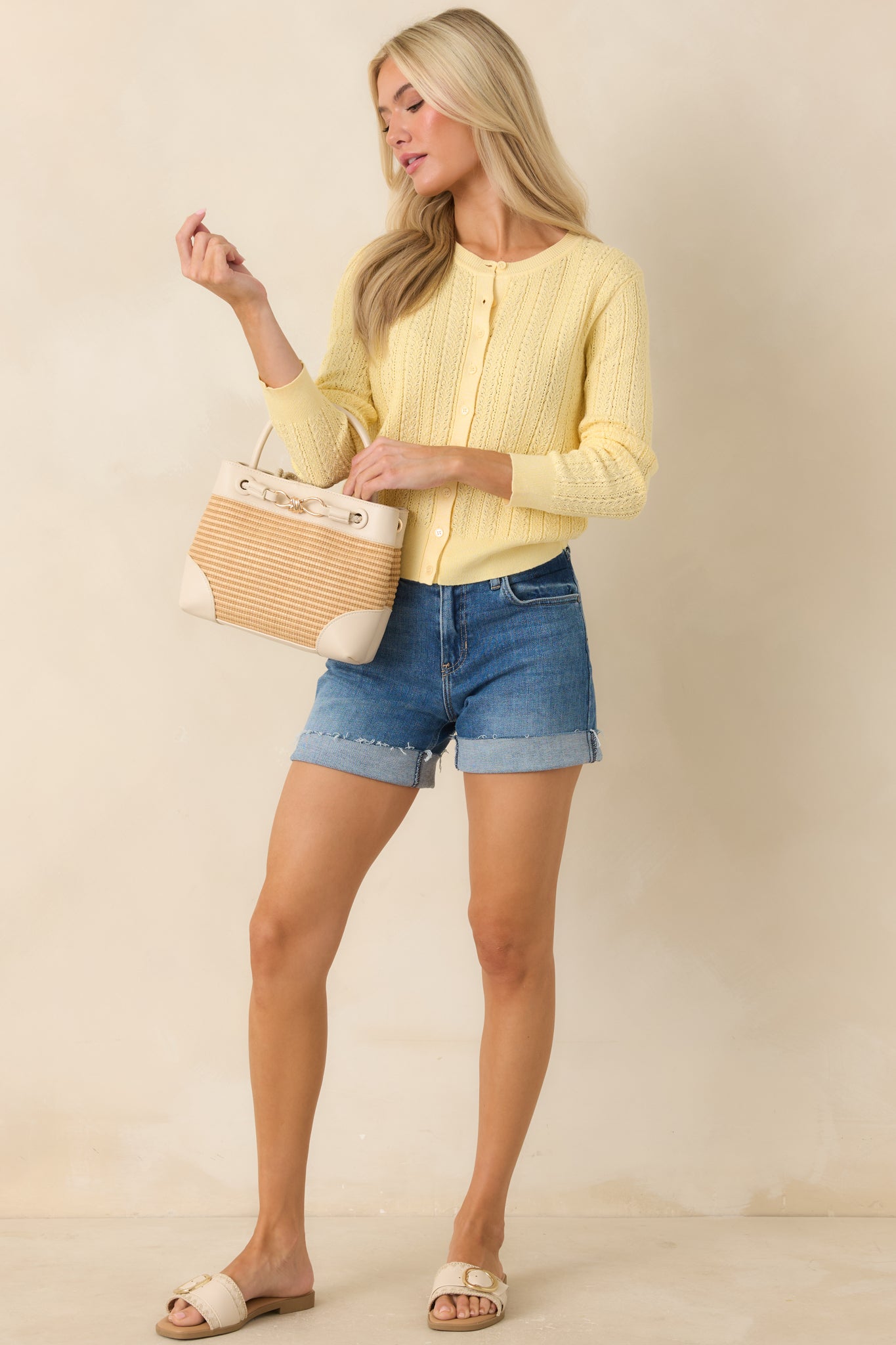 Cropped knit cardigan with delicate texture, front buttons, and breathable openwork design.