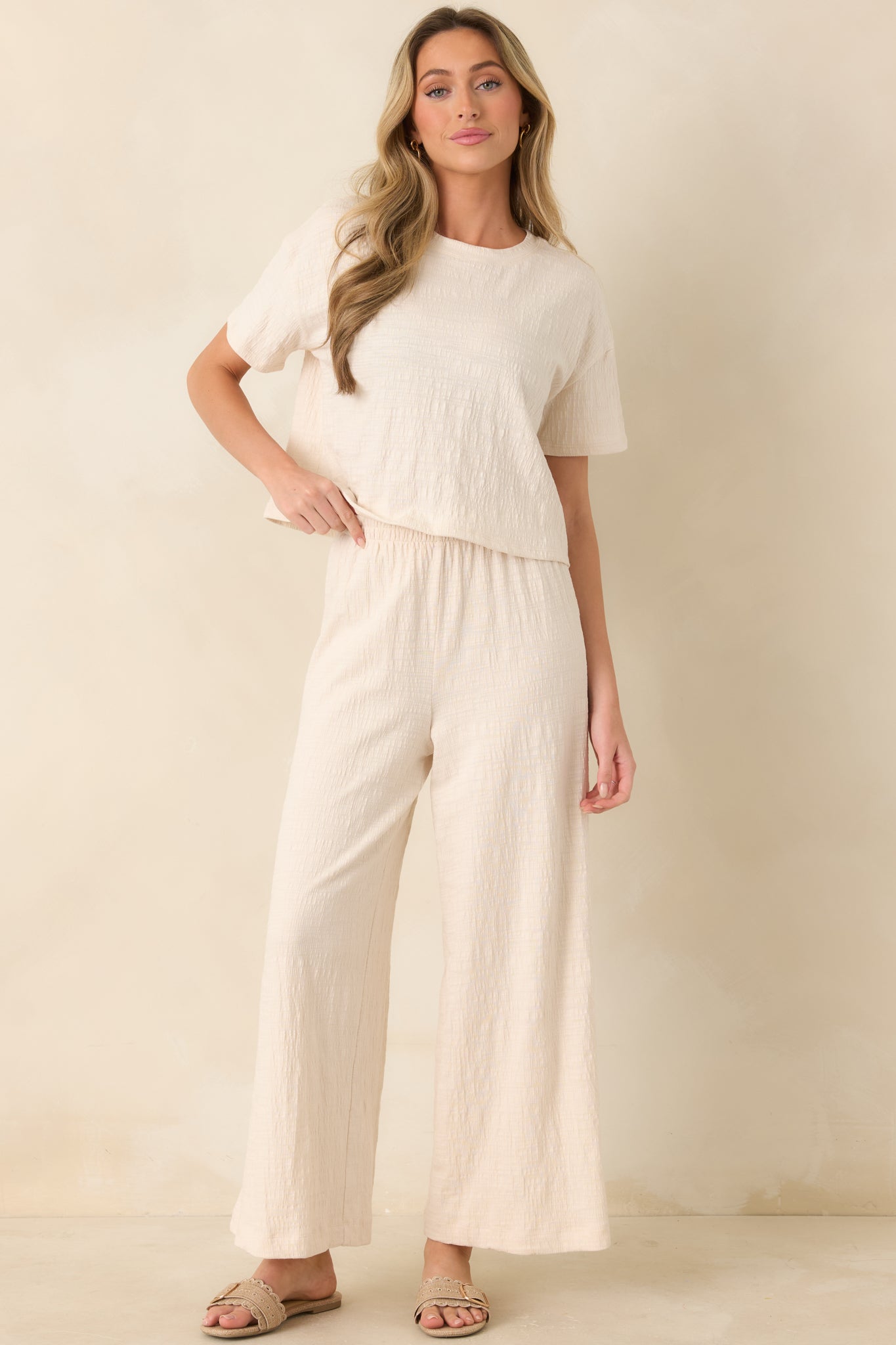 Relaxed ivory crew-neck tee with cropped waist-length hem and subtle texture.