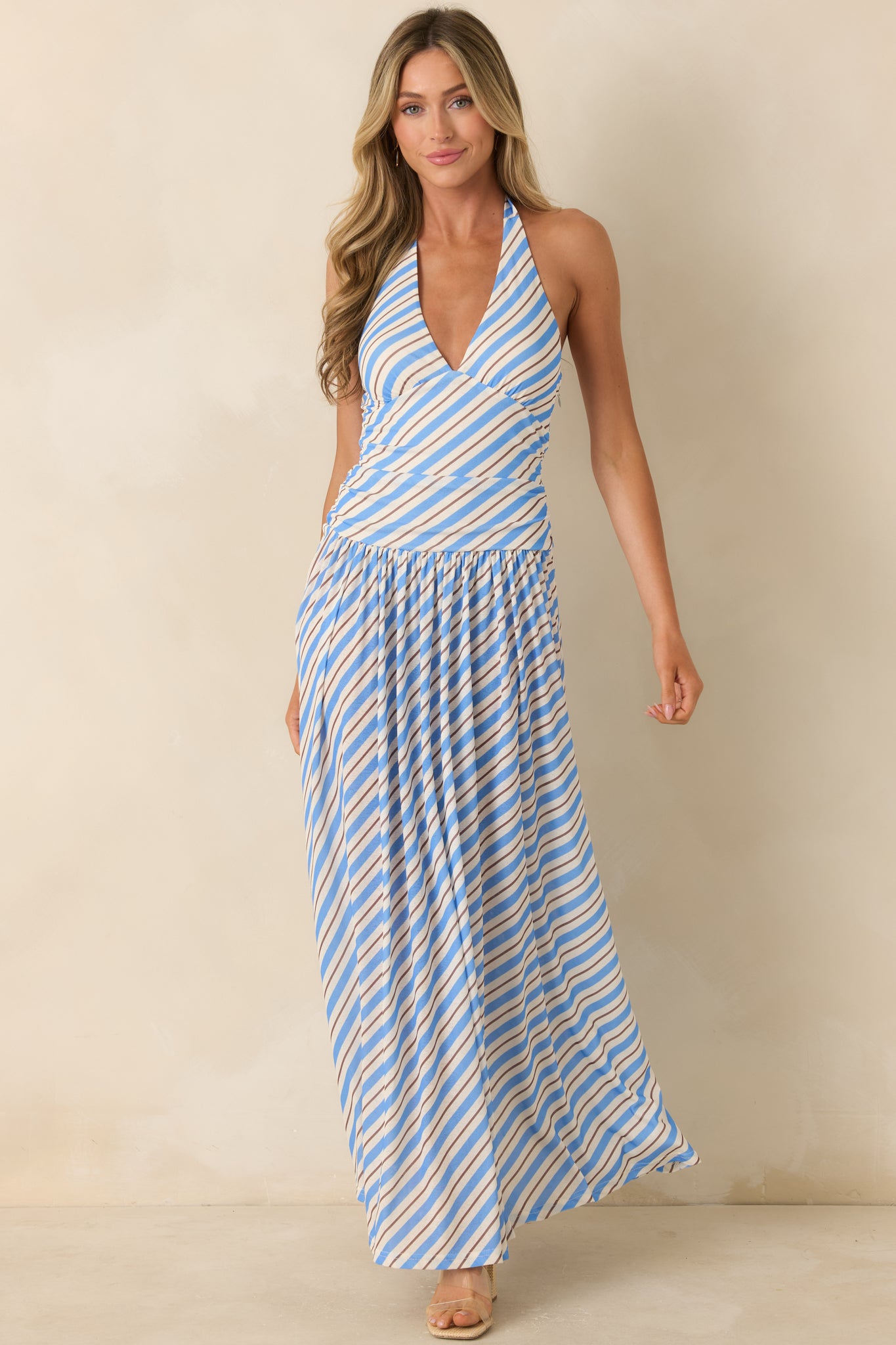 Lightweight blue and ivory striped maxi dress showcasing a fitted waist and flowing full-length skirt.