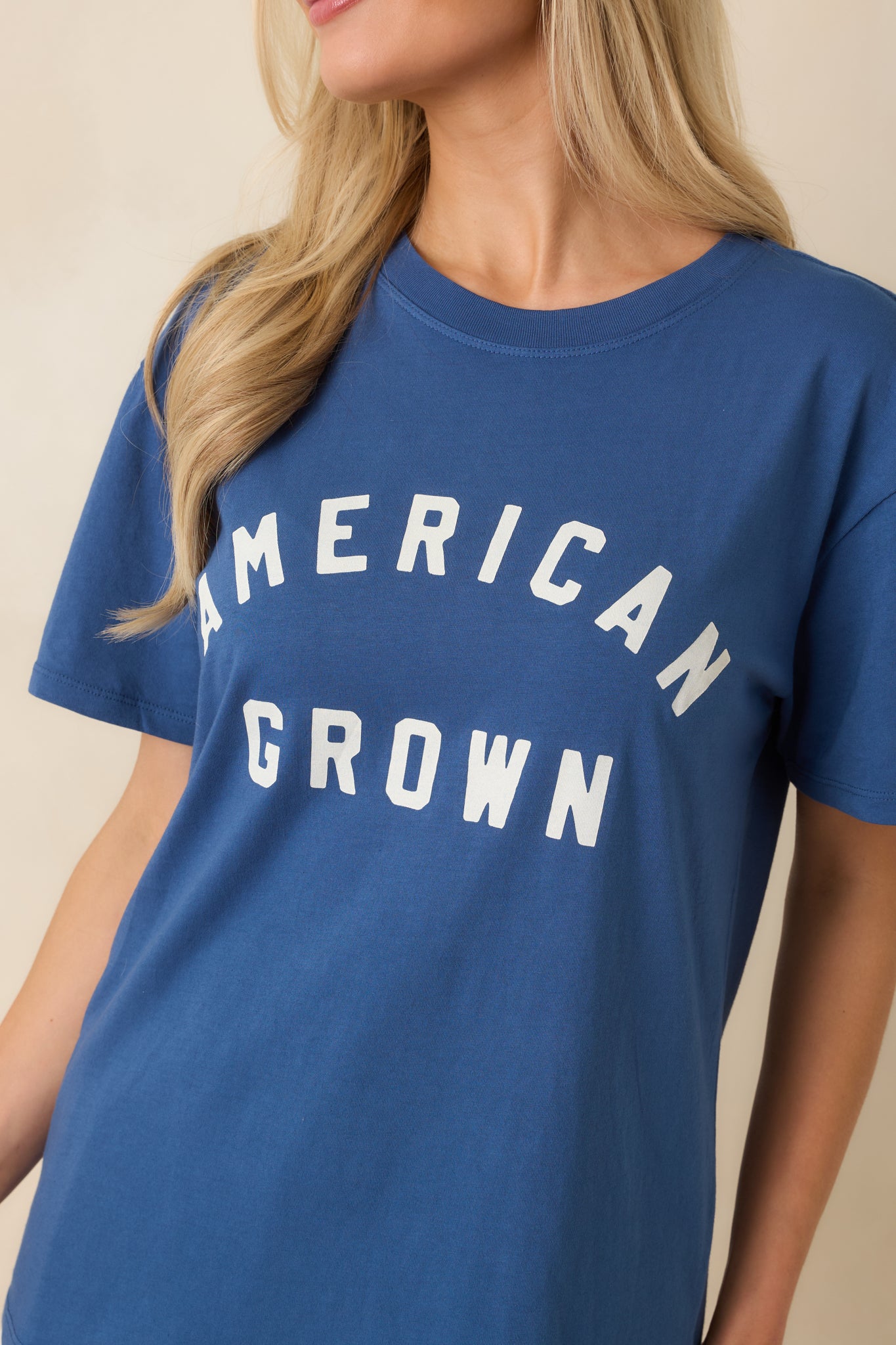 Close-up of the graphic print showing crisp white “American Grown” lettering against the deep blue cotton fabric.