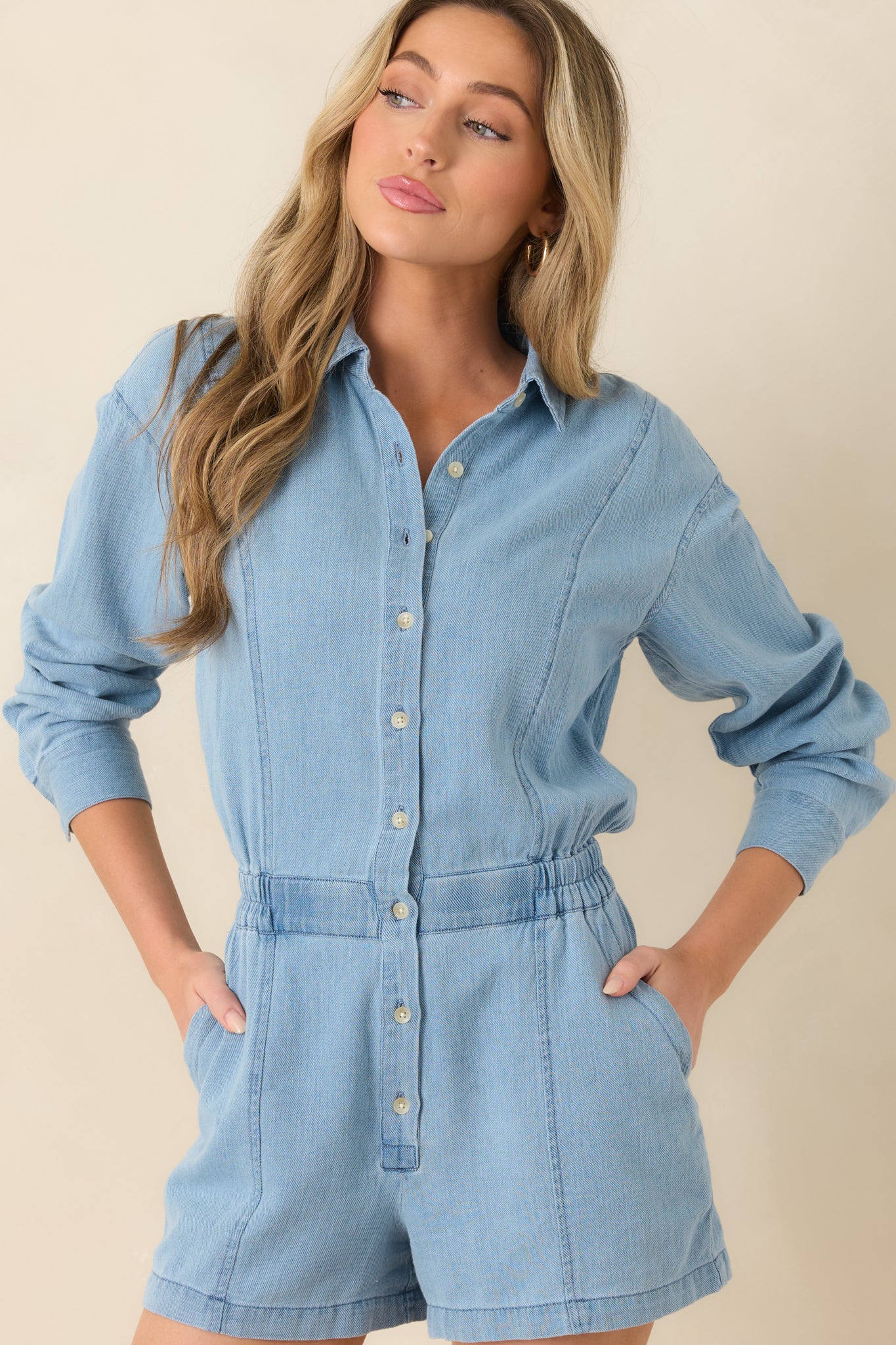 Close view of collared neckline with button front closure and soft twill texture.