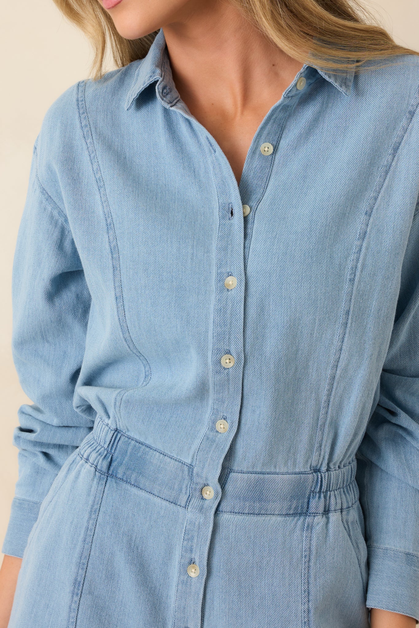 Detailed look at soft lake blue twill fabric with button front and stitched pocket detail.