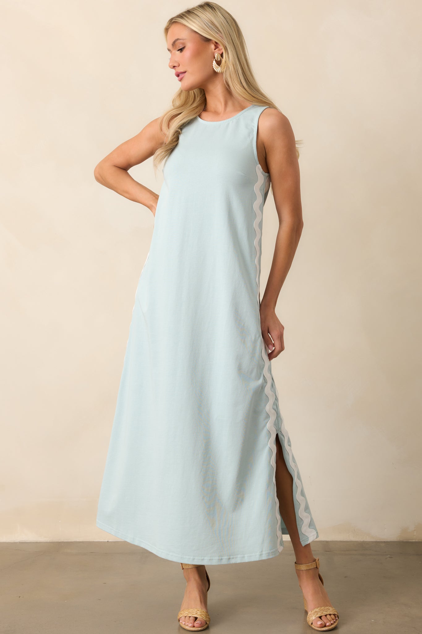 A flowing blue maxi dress made from 100% cotton, designed with side bottom hem vent slits for ease of movement.