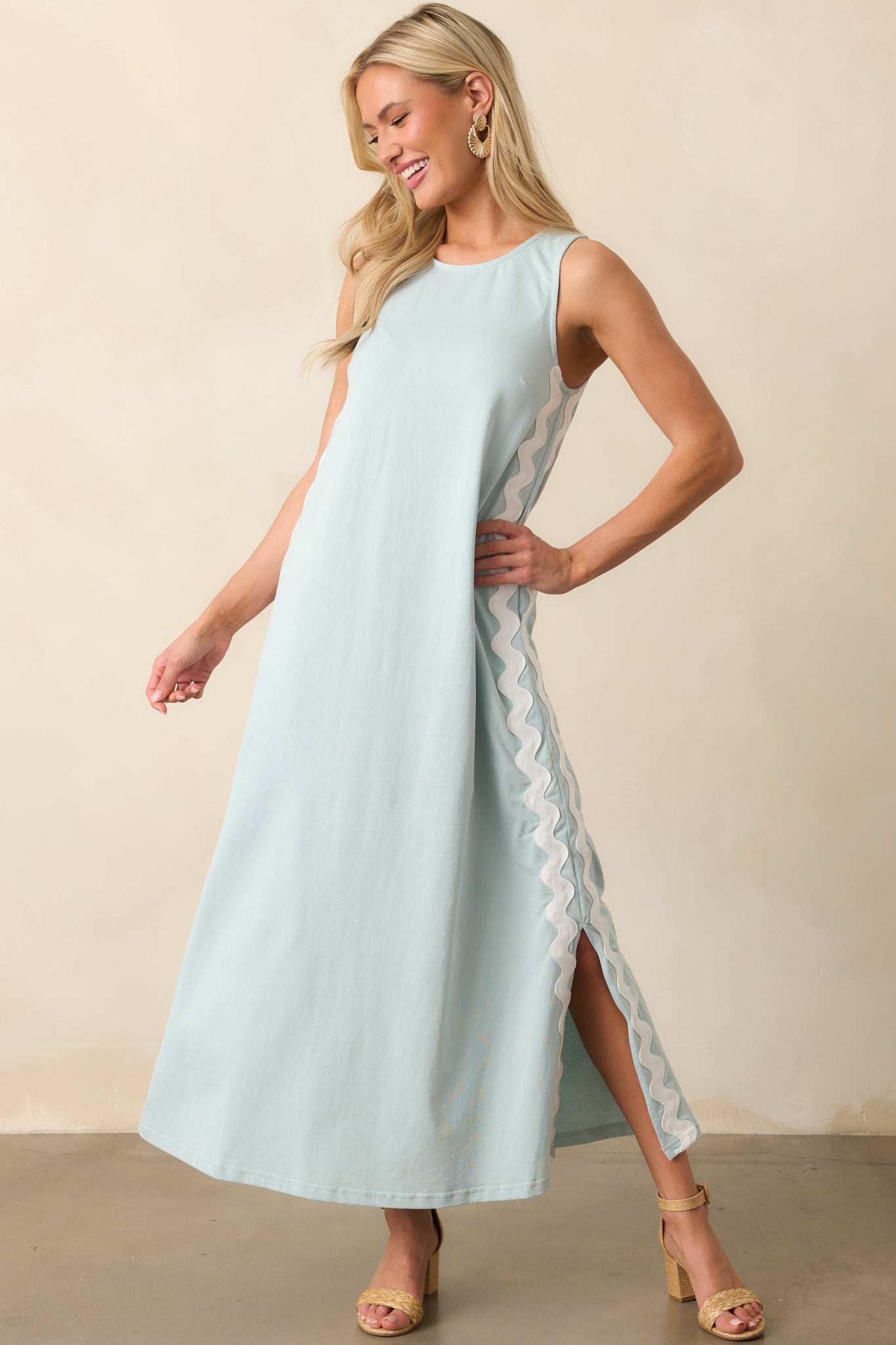 A soft blue maxi dress with a straight, comfortable fit, highlighted by vertical ric rac detailing and a sleeveless cut.
