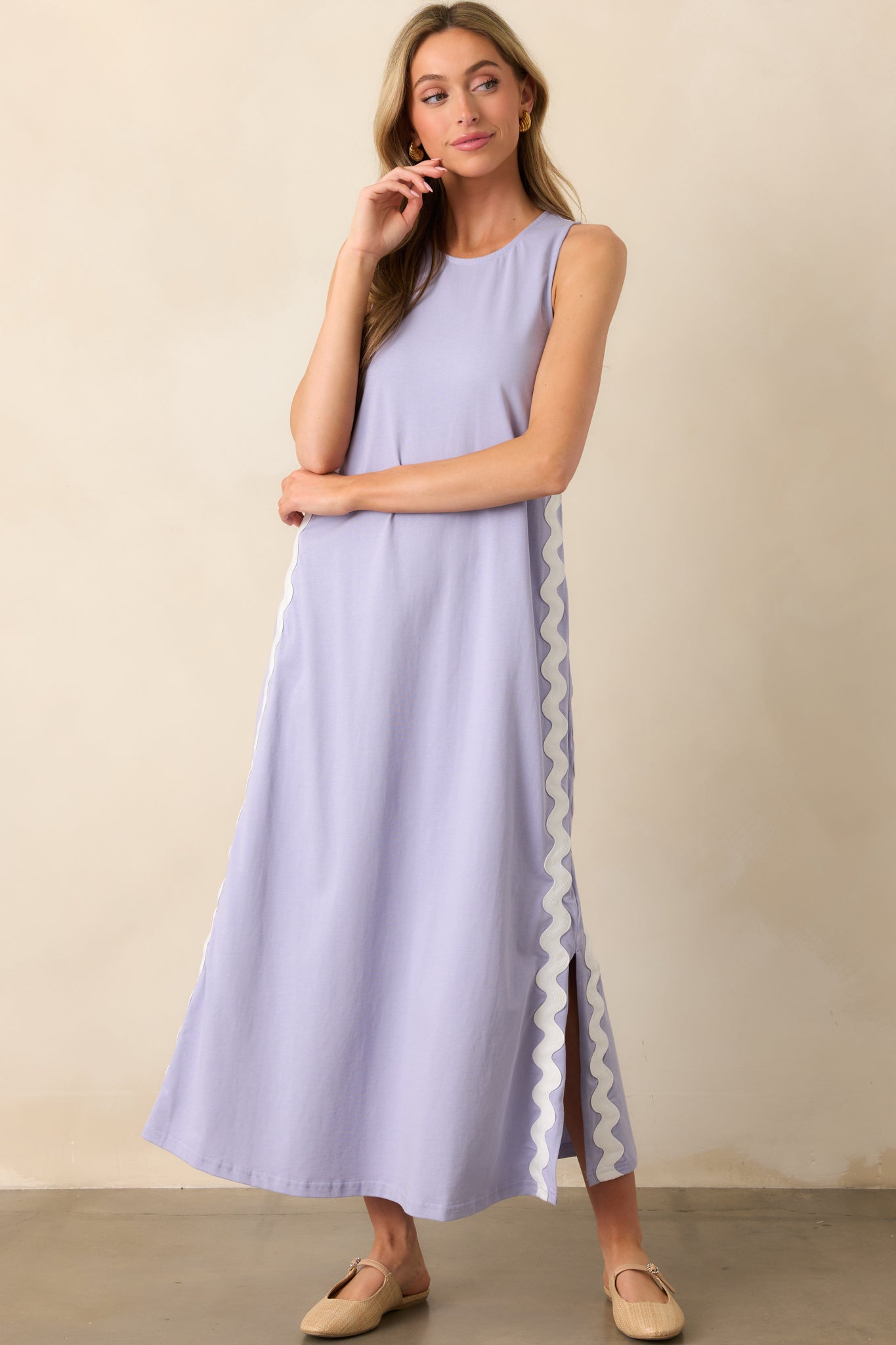 A lightweight purple maxi dress with a straight, comfortable fit, accented by decorative white ric rac trim and side slits for ease of wear.