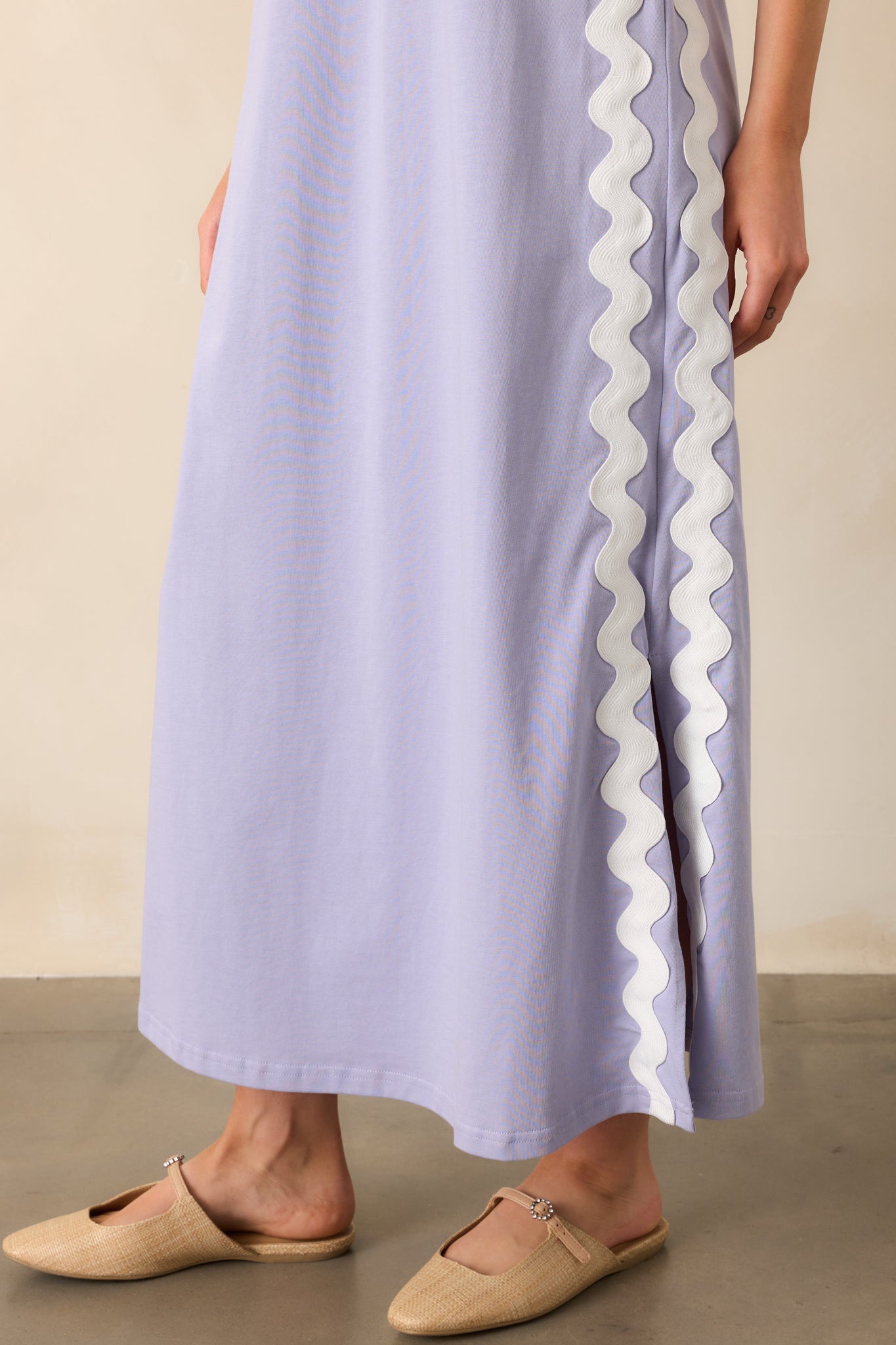 A zoomed-in view of the dress’s white ric rac trim, showing its intricate placement along the soft cotton fabric.