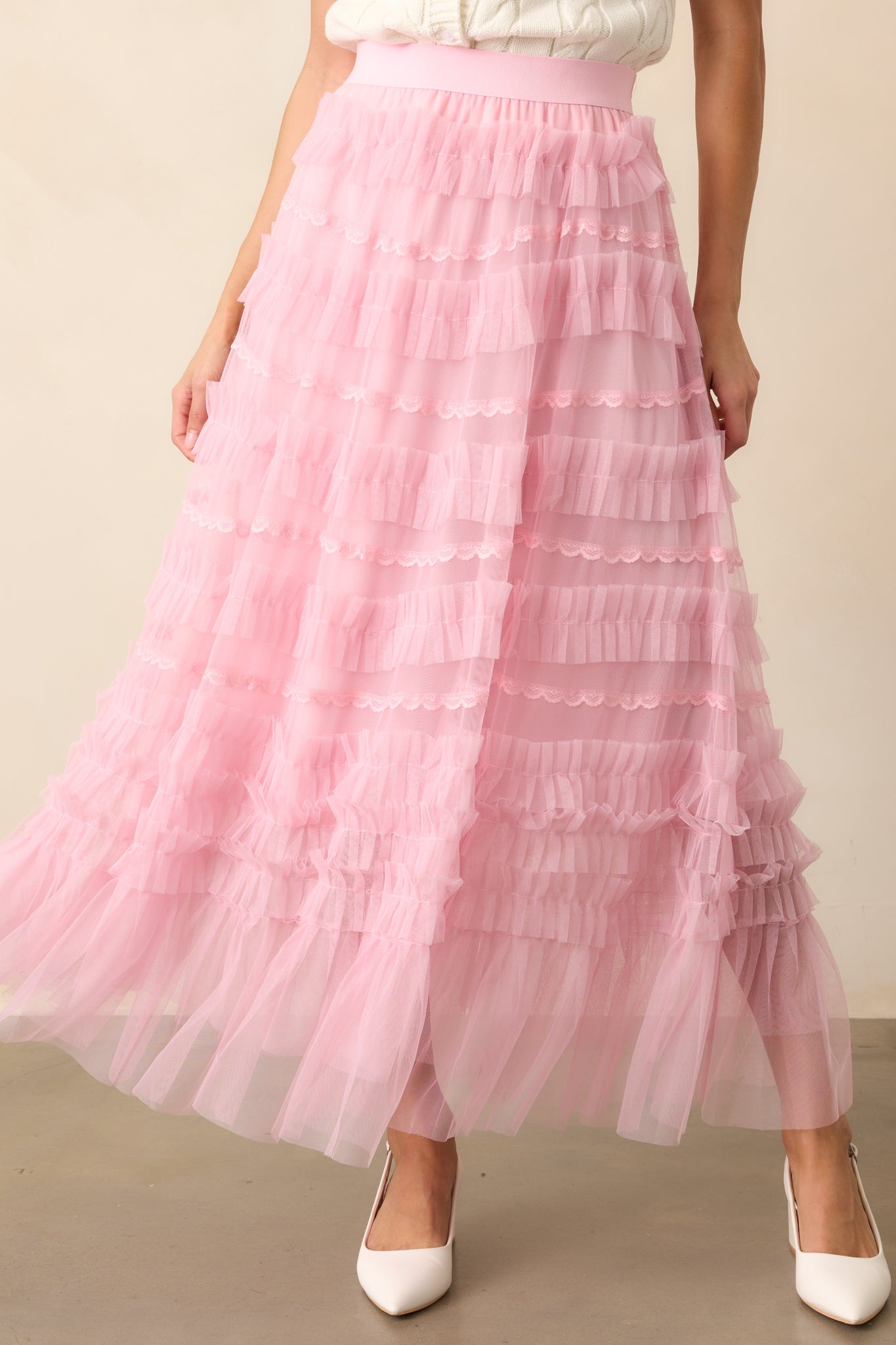 The intricate lace and soft tulle layers of this light pink skirt create a beautifully textured, feminine look.