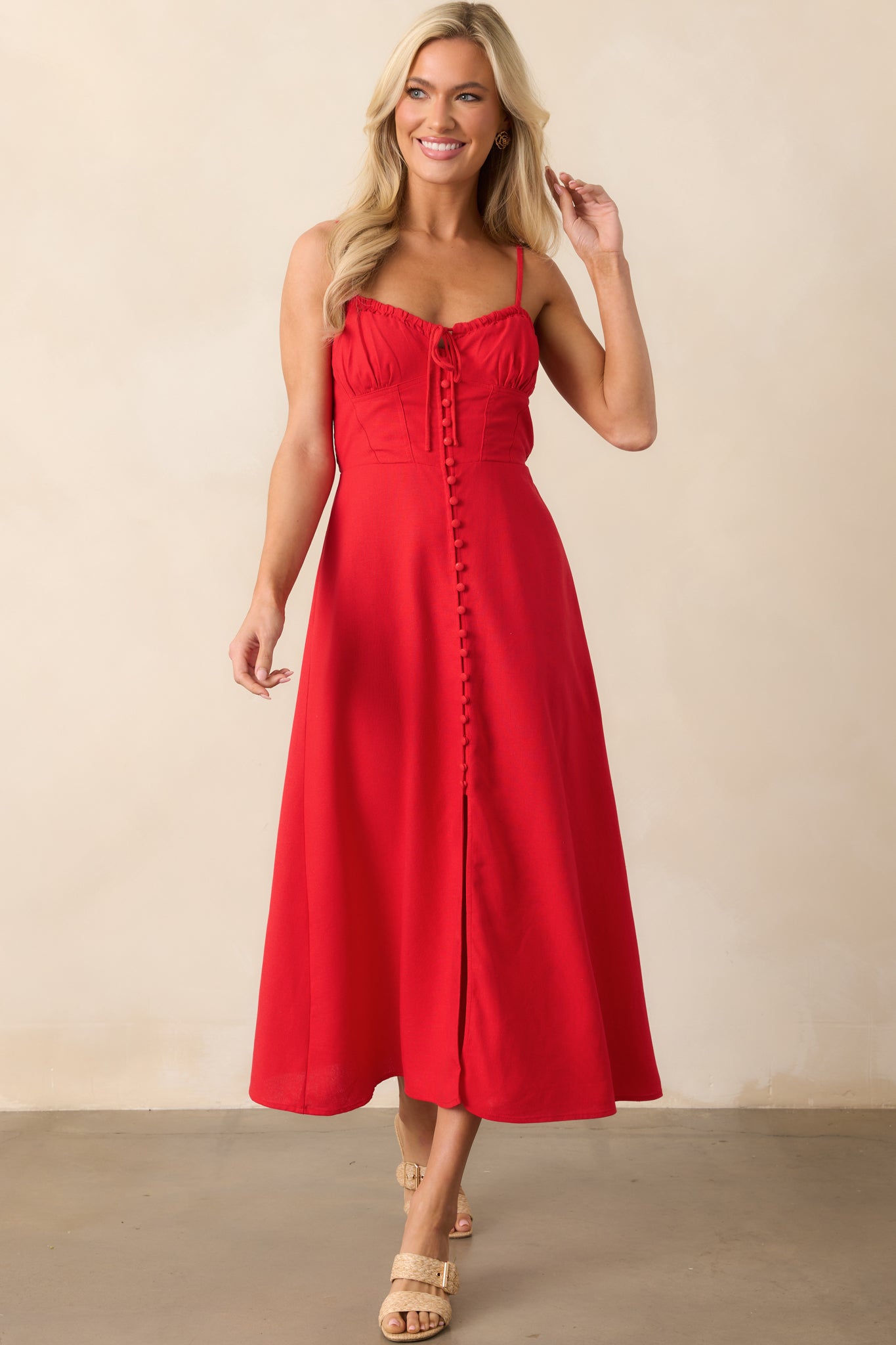 Front view of a red dress with adjustable straps, showcasing the self-tie bust and corset front design.