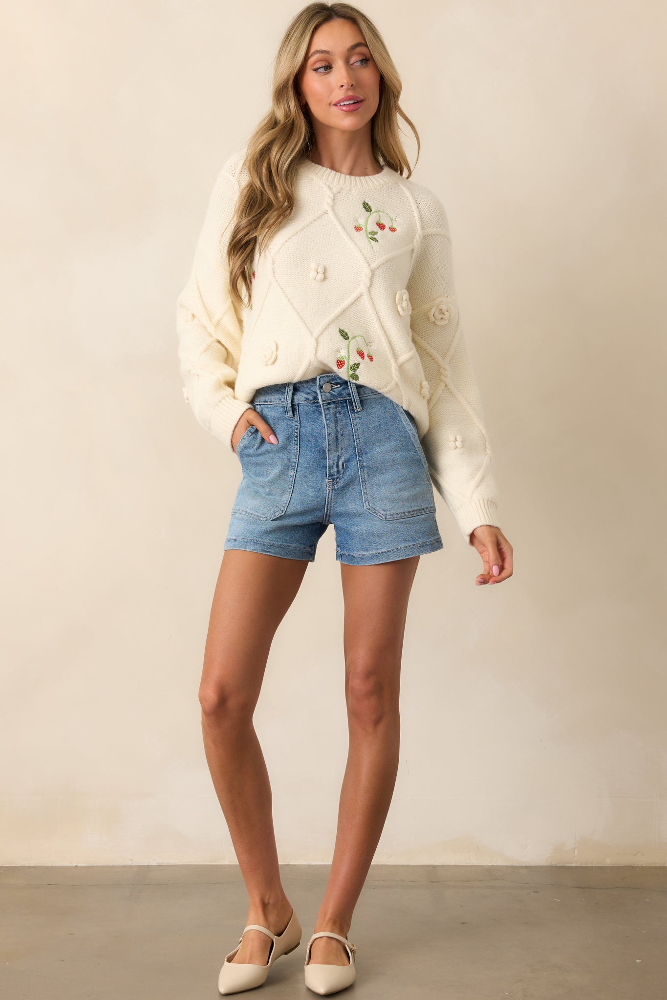 Front view of light denim shorts featuring high-rise waist and structured silhouette.
