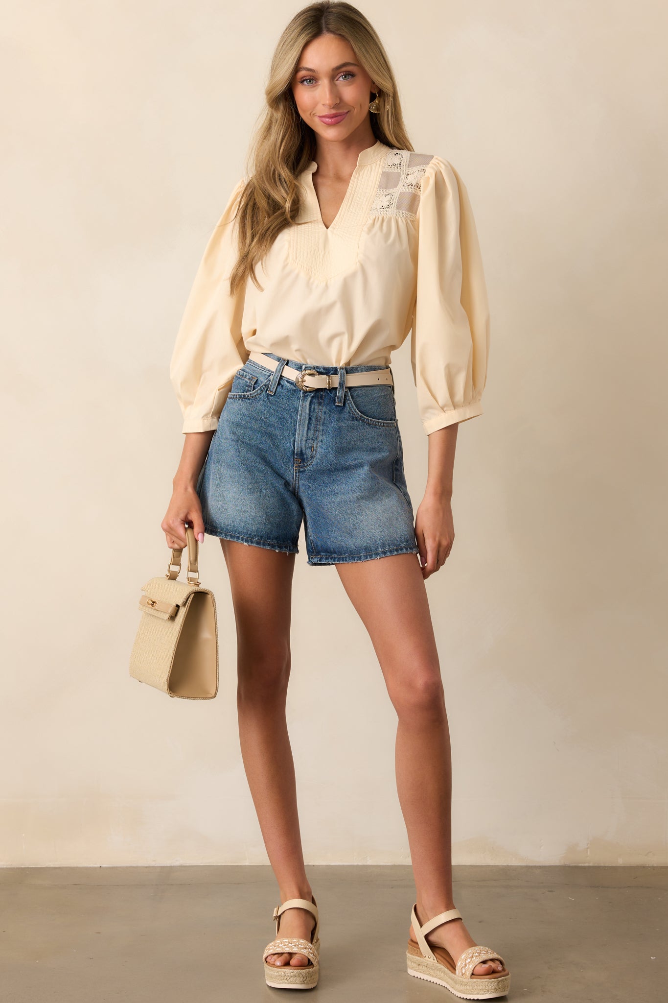 A front-facing view of the high-rise shorts, showcasing the functional 5-pocket design, belt loops, and classic button zipper closure for a clean, versatile look.