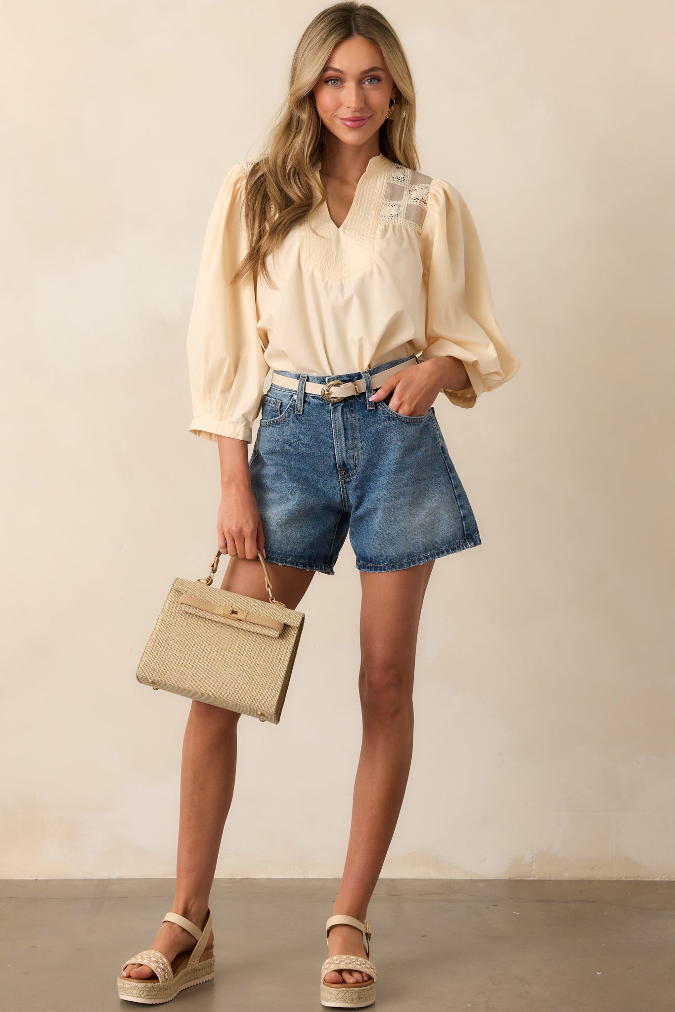 A complete look at the blouse, highlighting the puff sleeves and flowing silhouette.