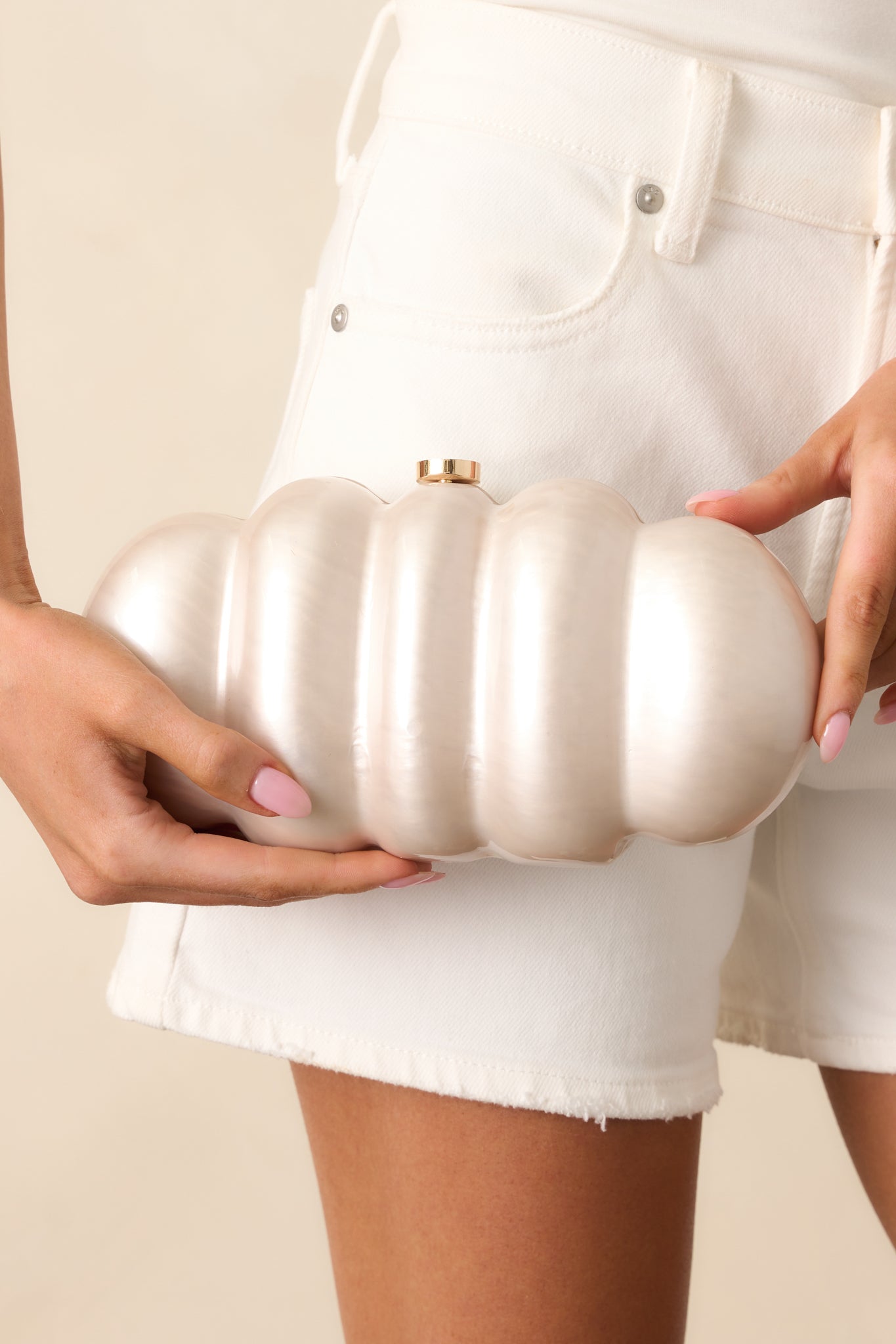 Close-up of the bag’s edge, capturing the smooth curve and soft luster of the ivory pearlescent finish.