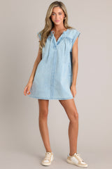 Full body view of this dress that features a v-neckline, a self-tie feature, gathering in the bust, a thick seam down the front and back, functional hip pockets, and wide cuffed short sleeves.