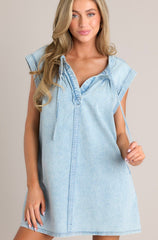 Front view of this dress that features a v-neckline, a self-tie feature, gathering in the bust, a thick seam down the front and back, functional hip pockets, and wide cuffed short sleeves.