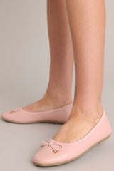 Full view of these flats that feature a square toe, bow detail, a matte finish, and a memory foam insole.