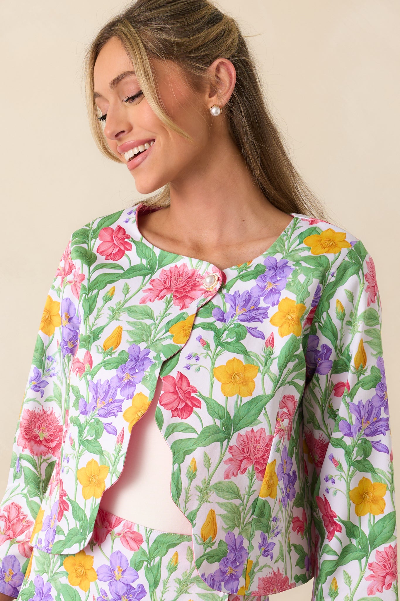 A focused view of the exclusive Prosperina floral print on the reversible jacket, showcasing the intricate design and vibrant colors, with the scalloped hems adding a refined touch.