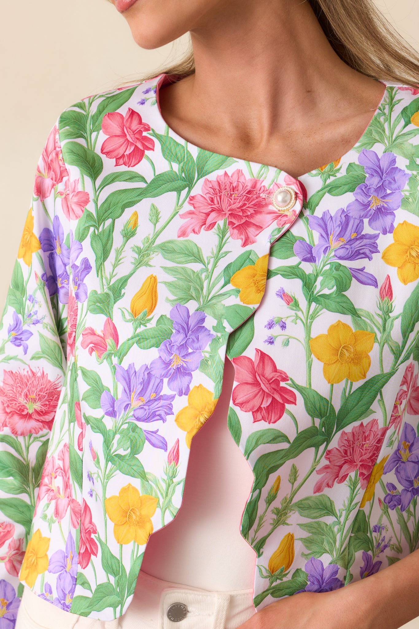 A close-up of the pearl top button design, highlighting the elegant detail and luxurious feel of the jacket.