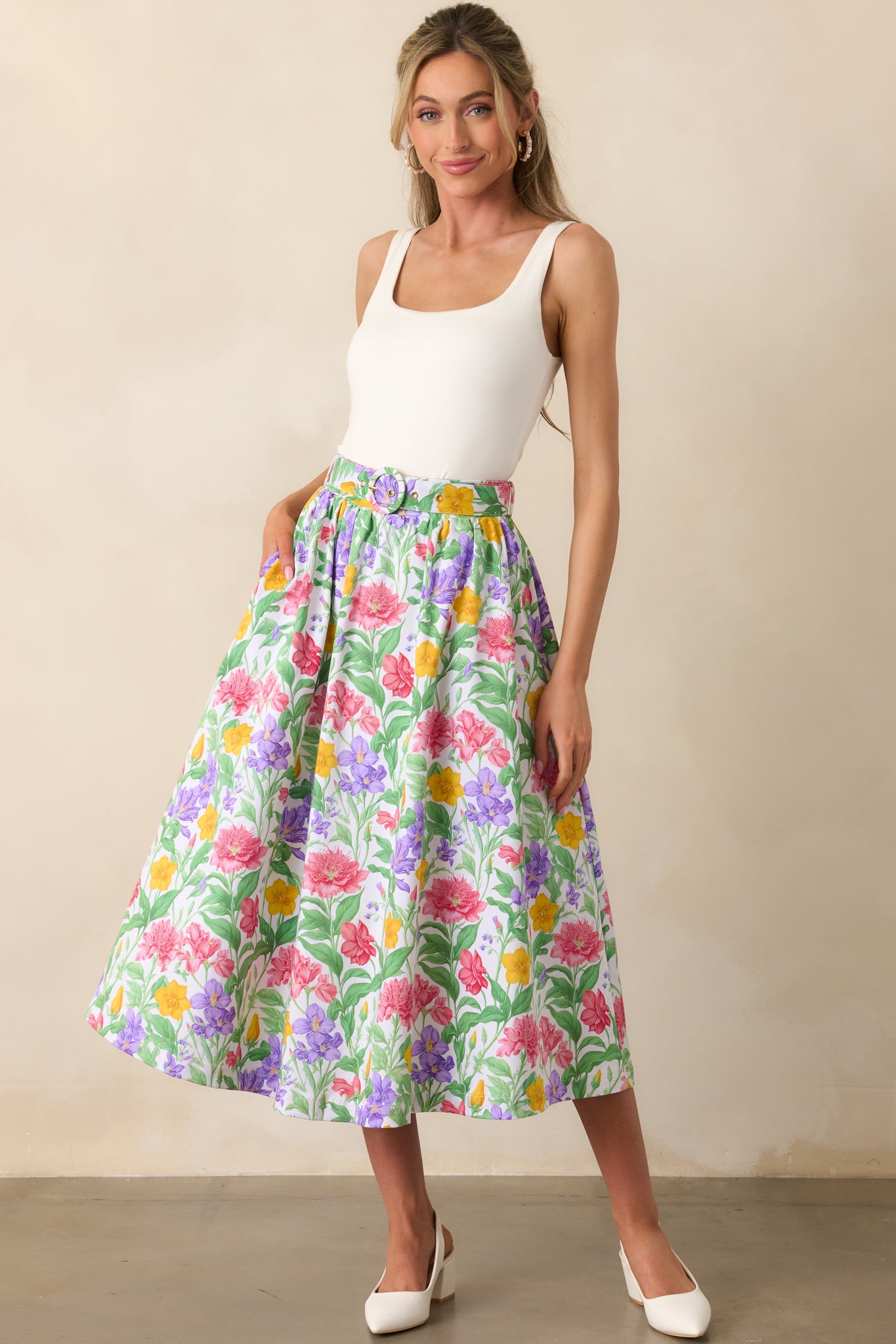 Bold Prosperina floral print midi skirt in a flattering cut, featuring an elastic waistband, belt loops, and a gold buckle on the matching adjustable belt for a polished look.