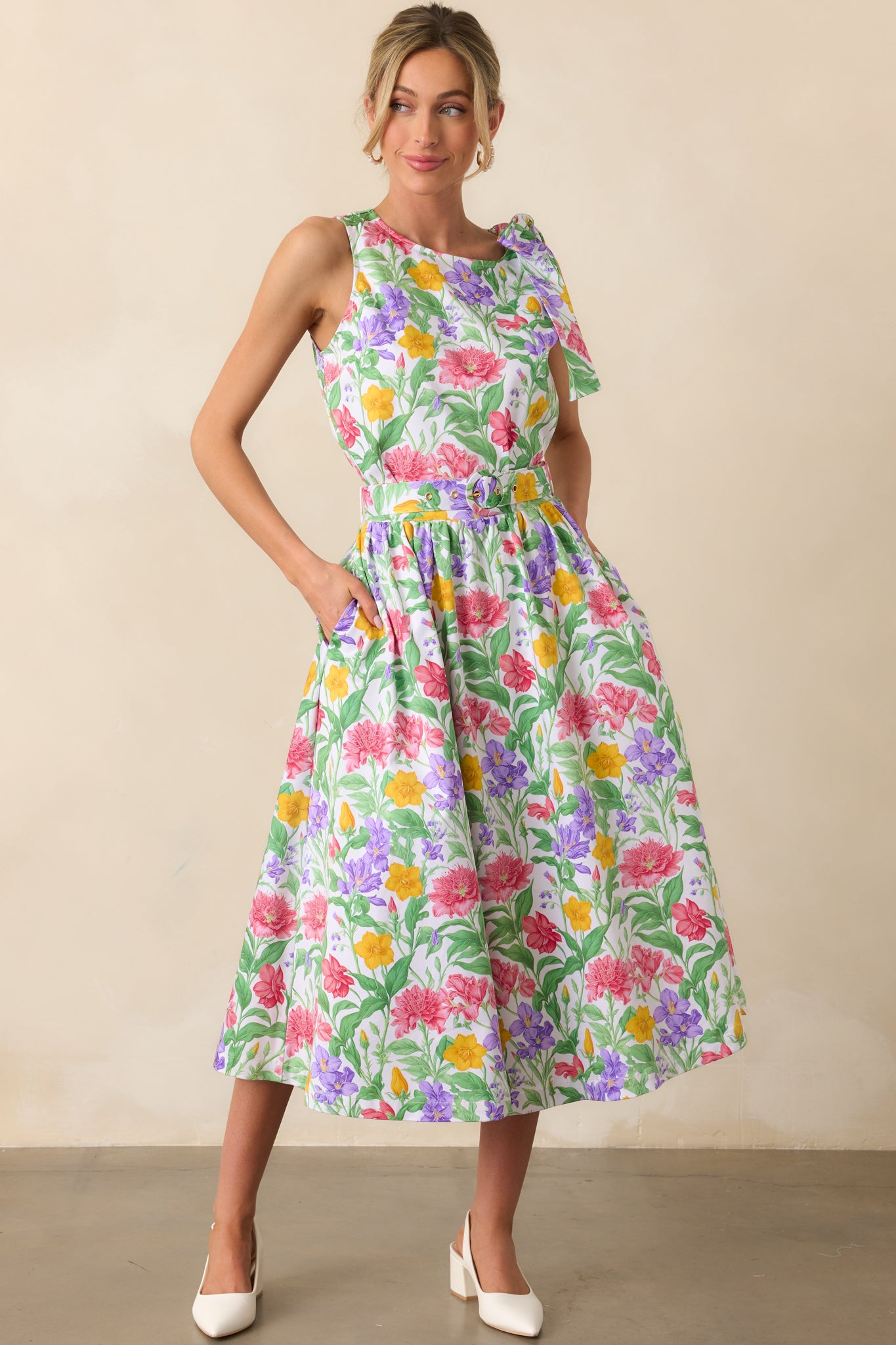 Prosperina floral print midi skirt with an elastic waist insert, functional pockets, and a matching adjustable belt with a gold buckle, flowing gracefully to a flattering A-line shape.