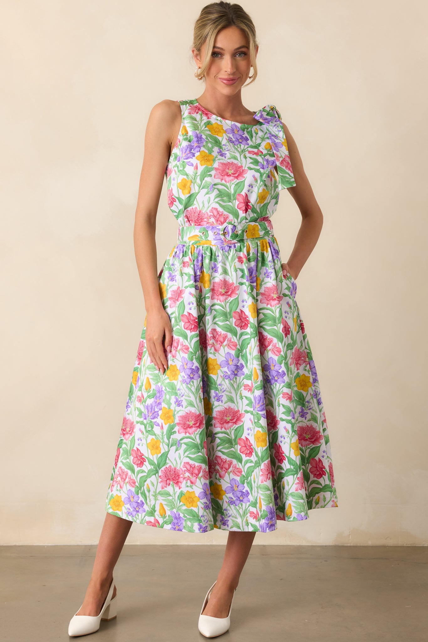 Prosperina exclusive floral print top featuring a round neckline, sleeveless design, and cropped length, with a self-tie bow detail on one shoulder.