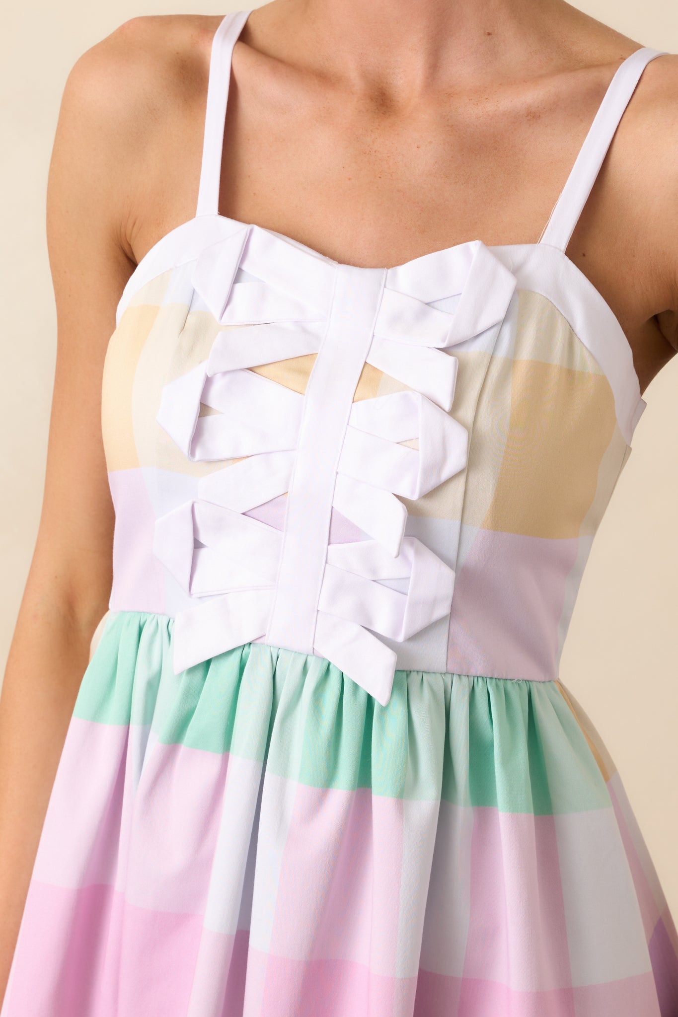 A zoomed-in look at the three bows down the center bodice, showcasing the intricate detailing and playful design.